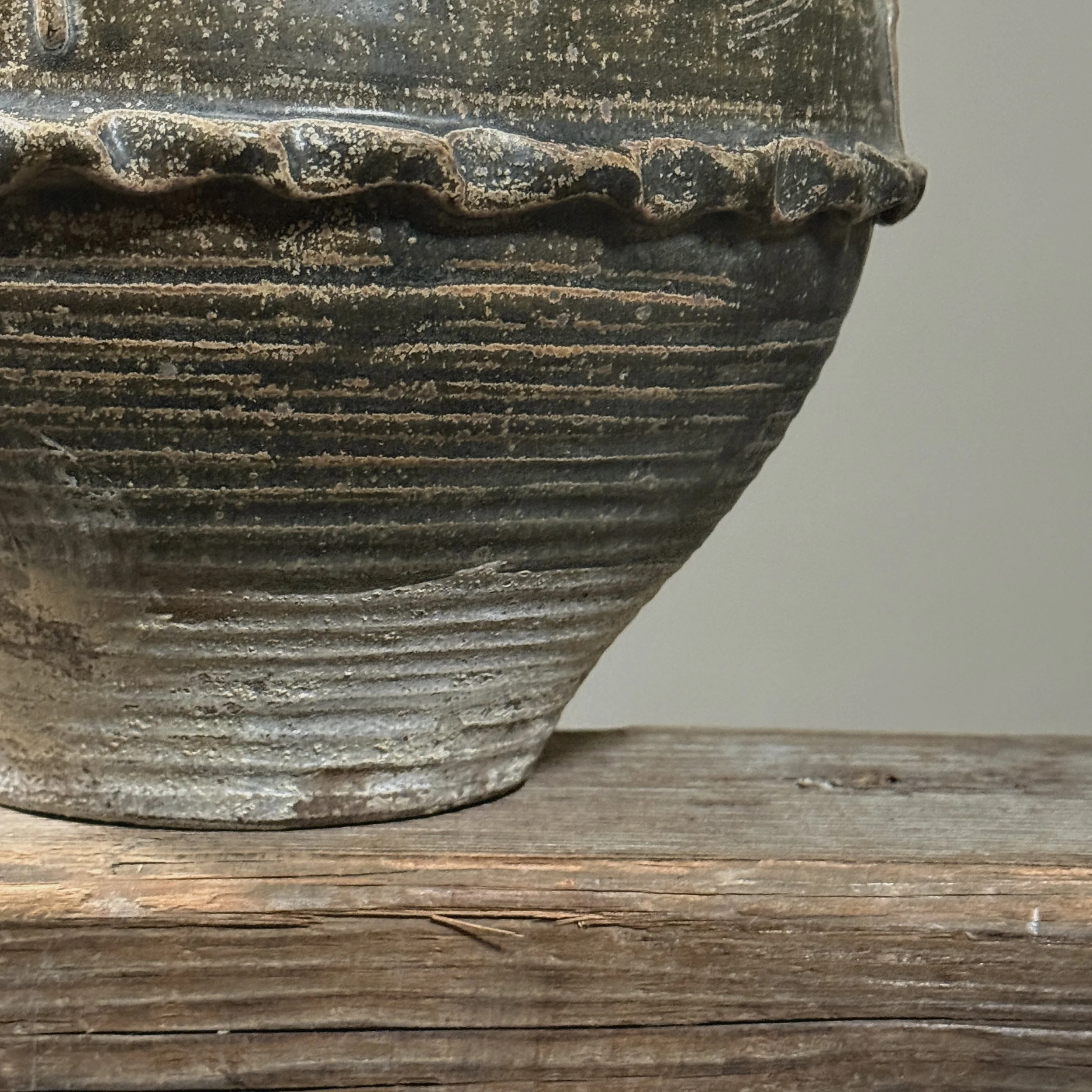 Detail of glaze texture and brownish-green coloration.