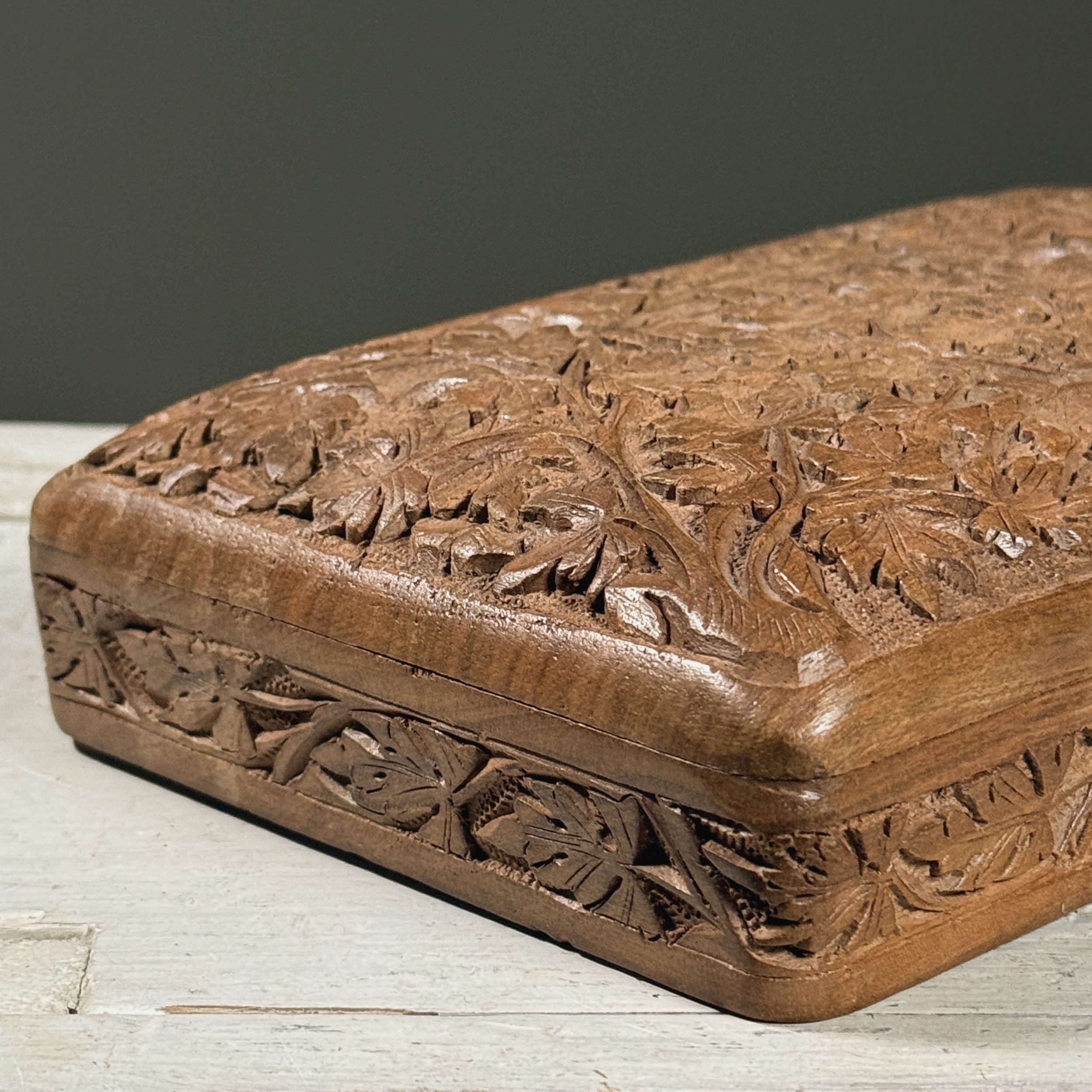 Macro detail of the chip-carving technique visible in the foliage pattern