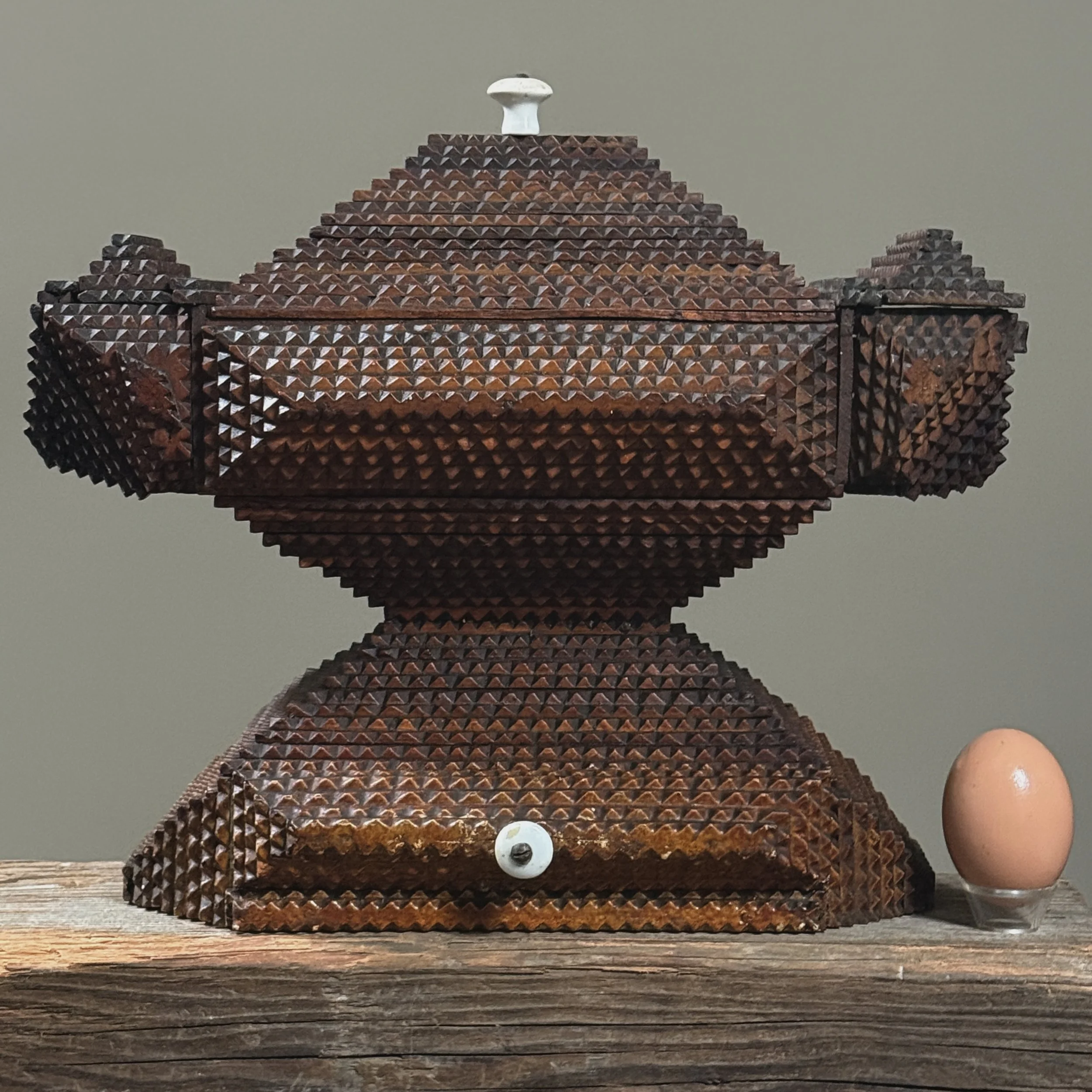 Antique American tramp art pyramid box showing overall construction with egg to show size