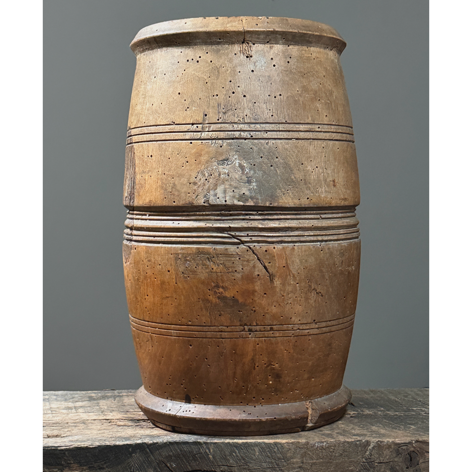 Front view of antique treenware barrel with concentric ribbed bands