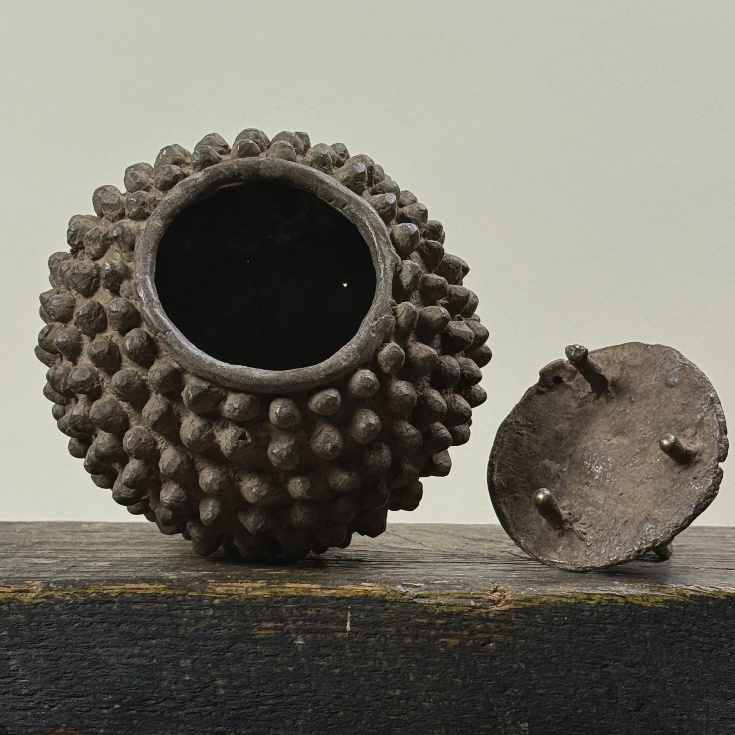 Open view of bronze box revealing interior cavity