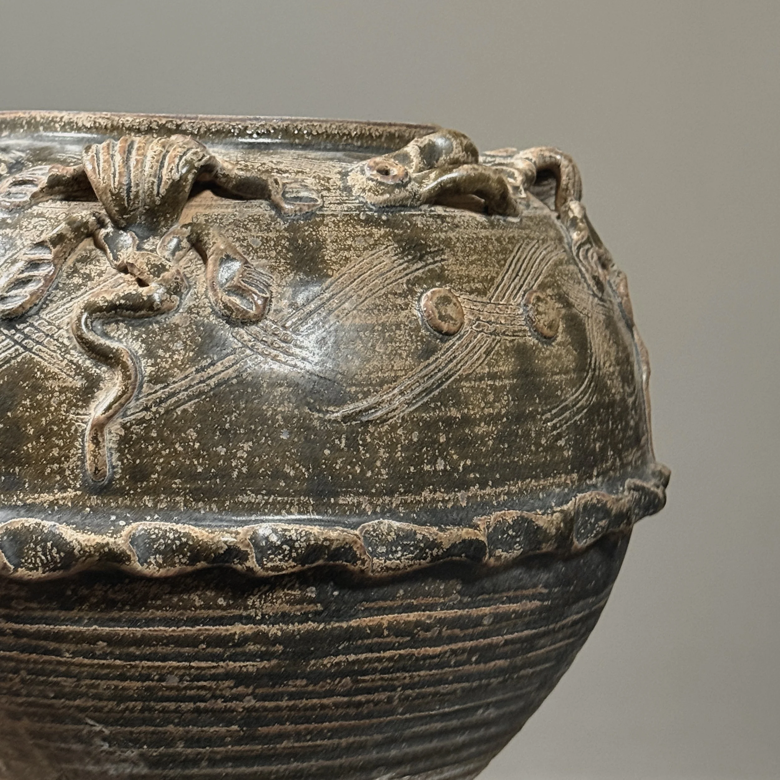 Detail of glaze texture and brownish-green coloration.