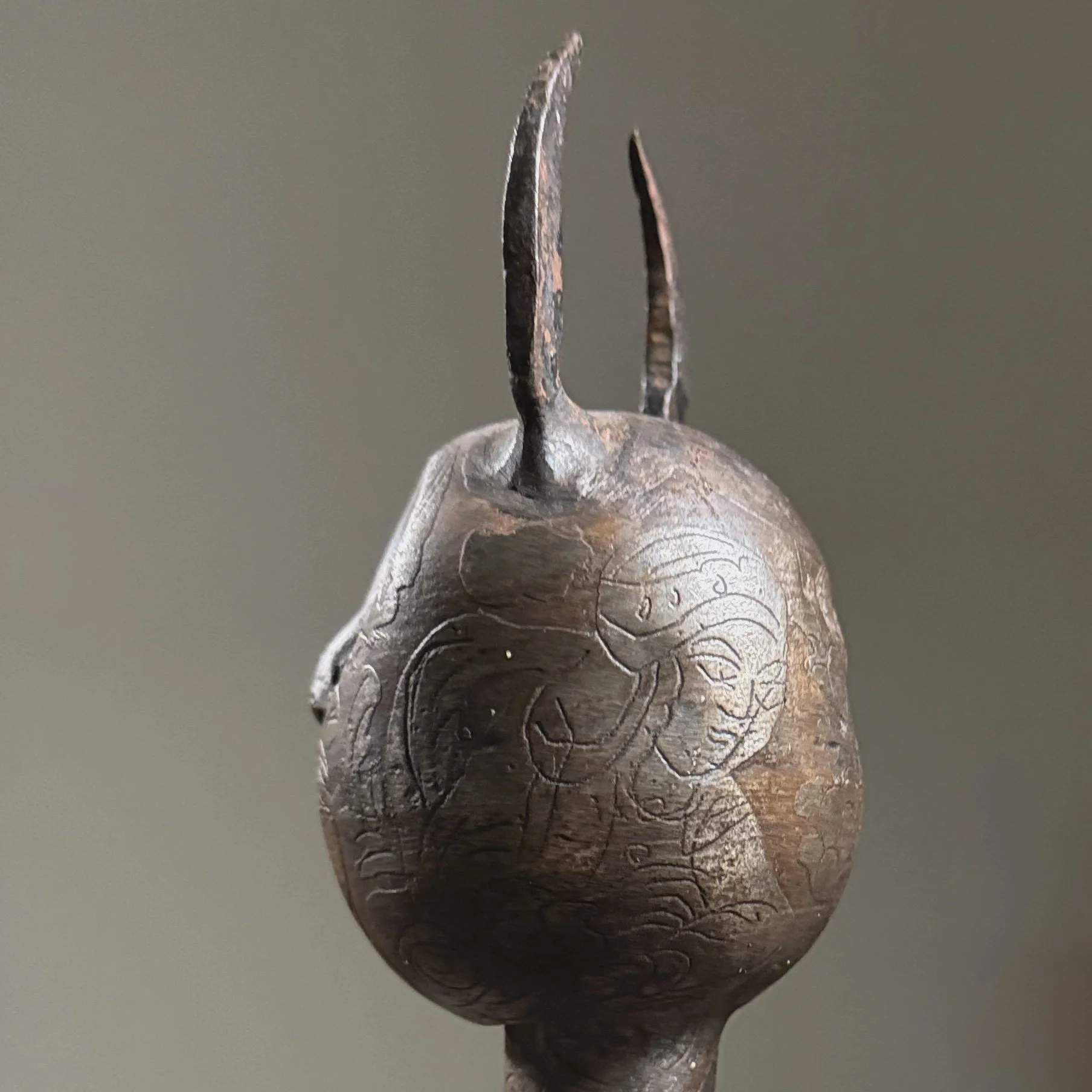 Close-up of one engraved human figure on reverse of mace head, 19th century style