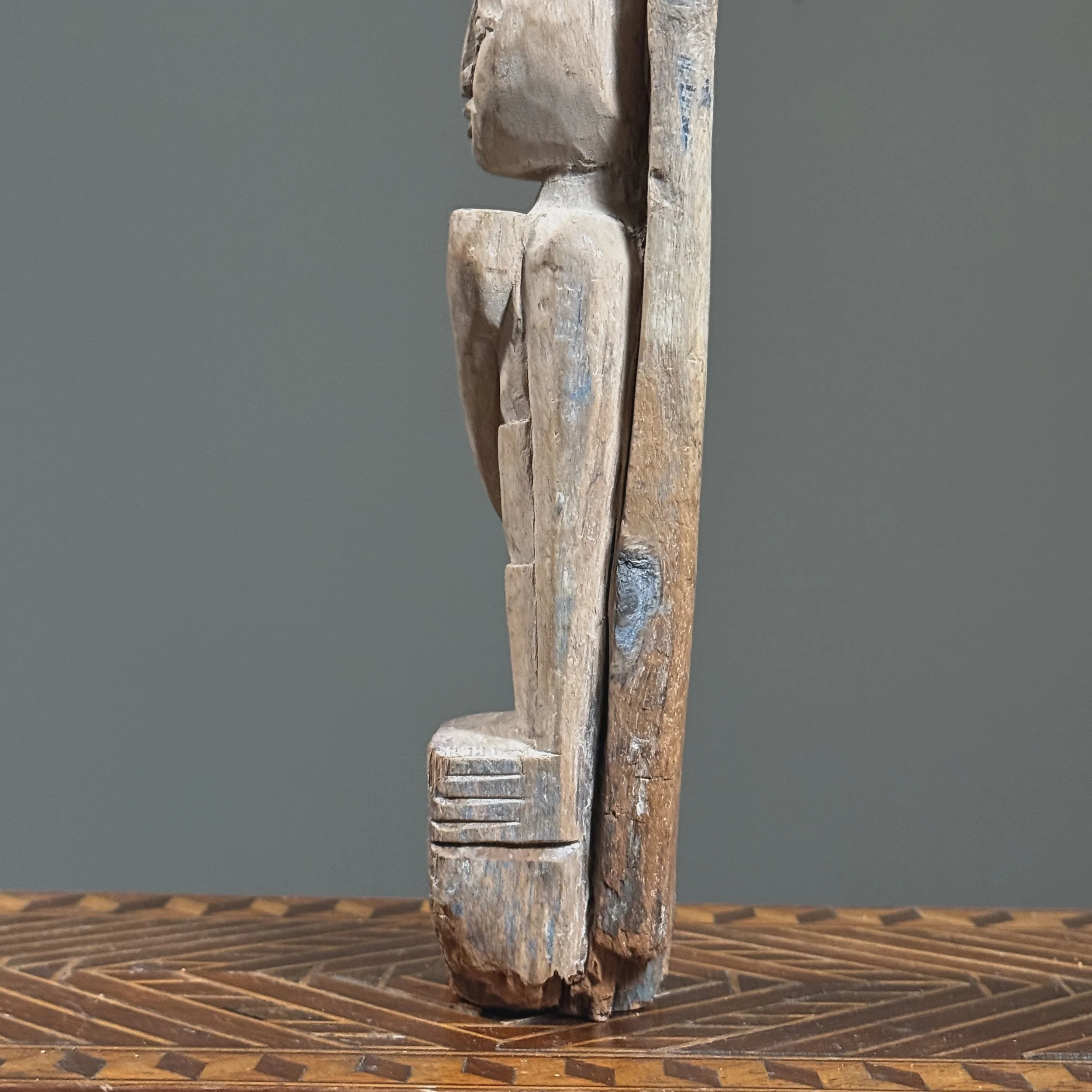 Surface wear and patina on antique wood carving