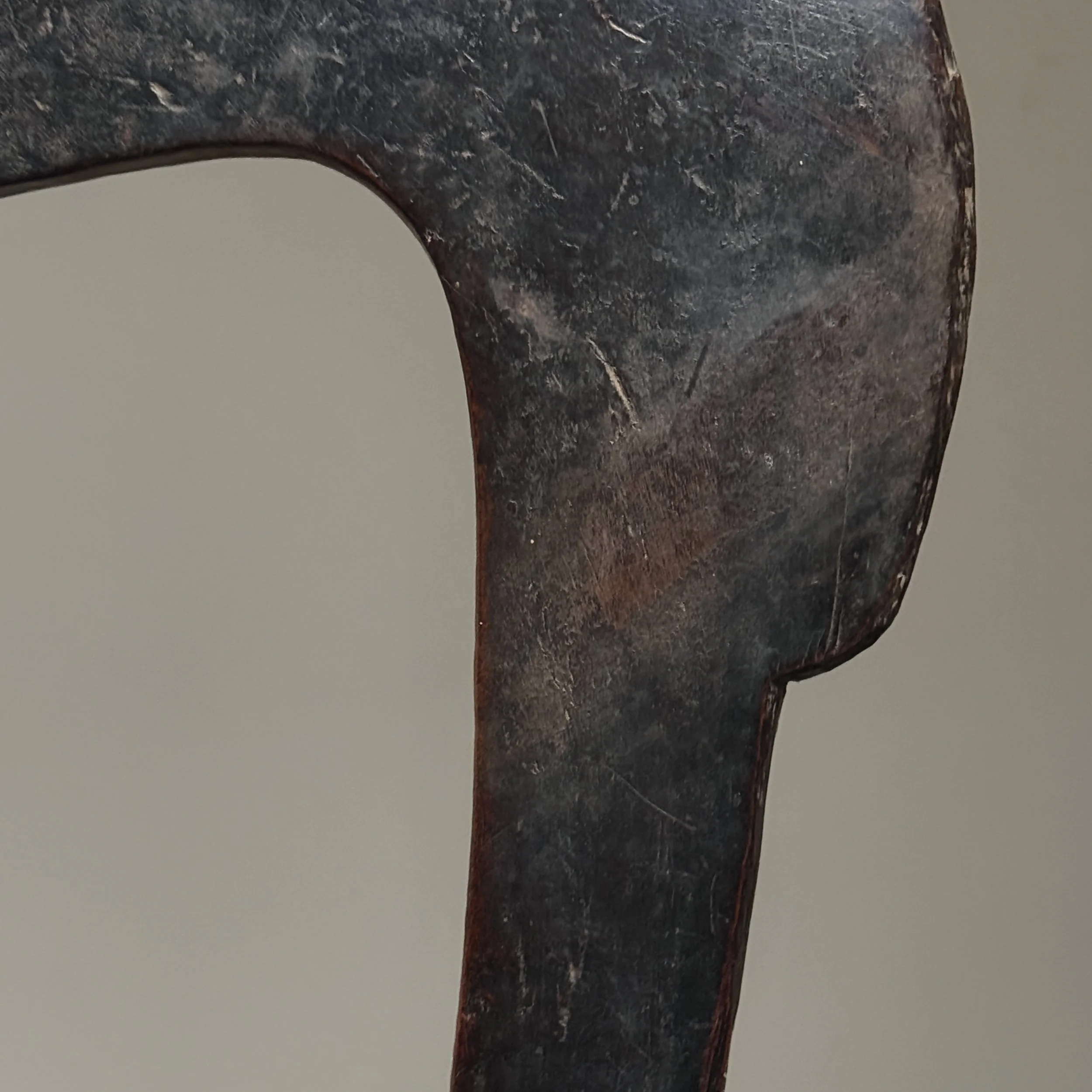 Carved feature close-up. Hand tool marks visible. Indigenous craftsmanship.