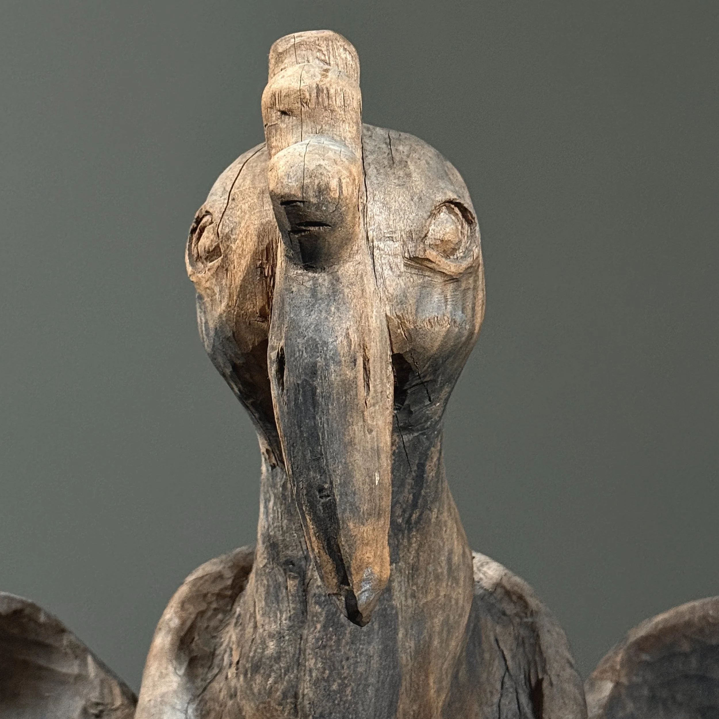 Folk art bird carving detail of head and beak