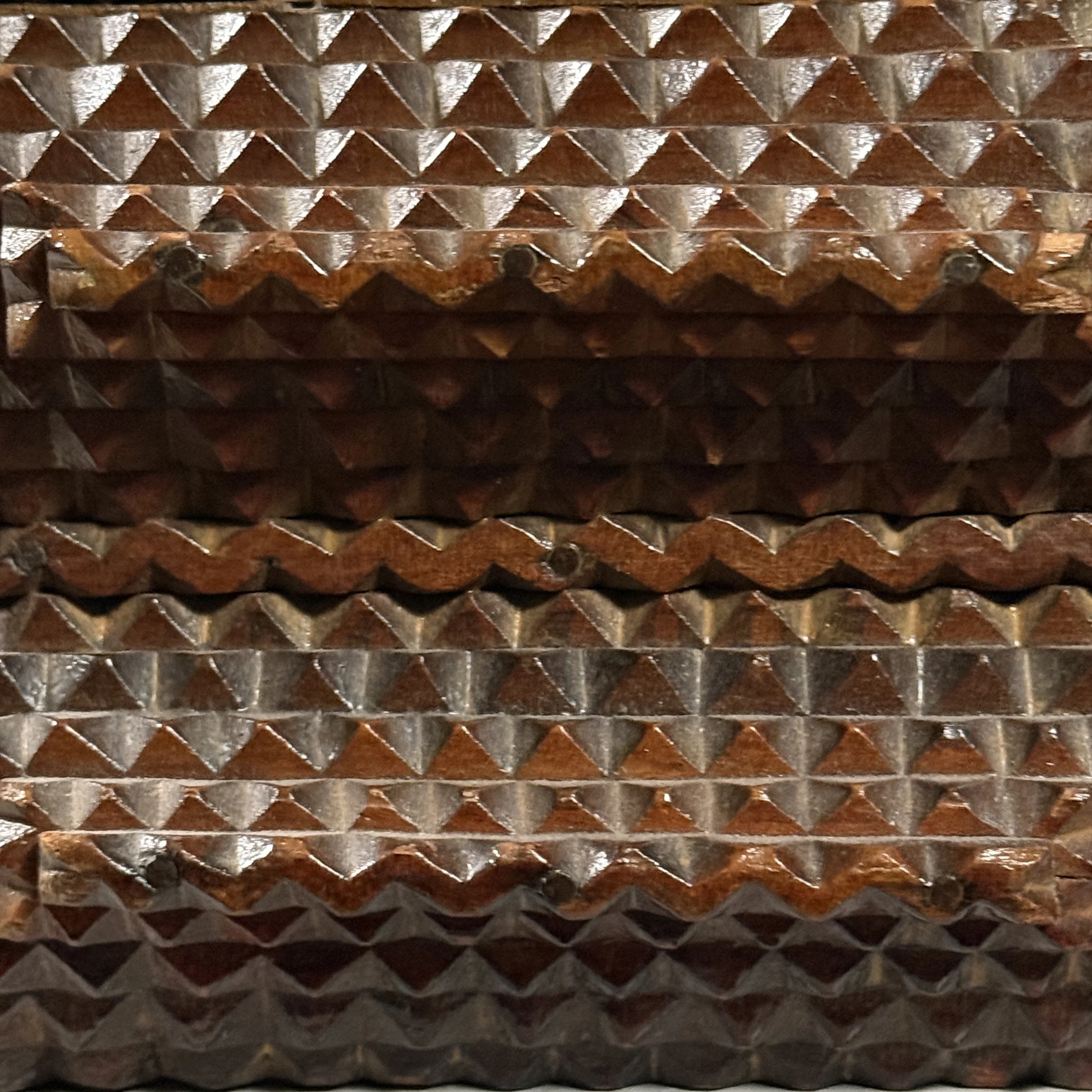 Close-up of pyramid chip carving on tramp art box