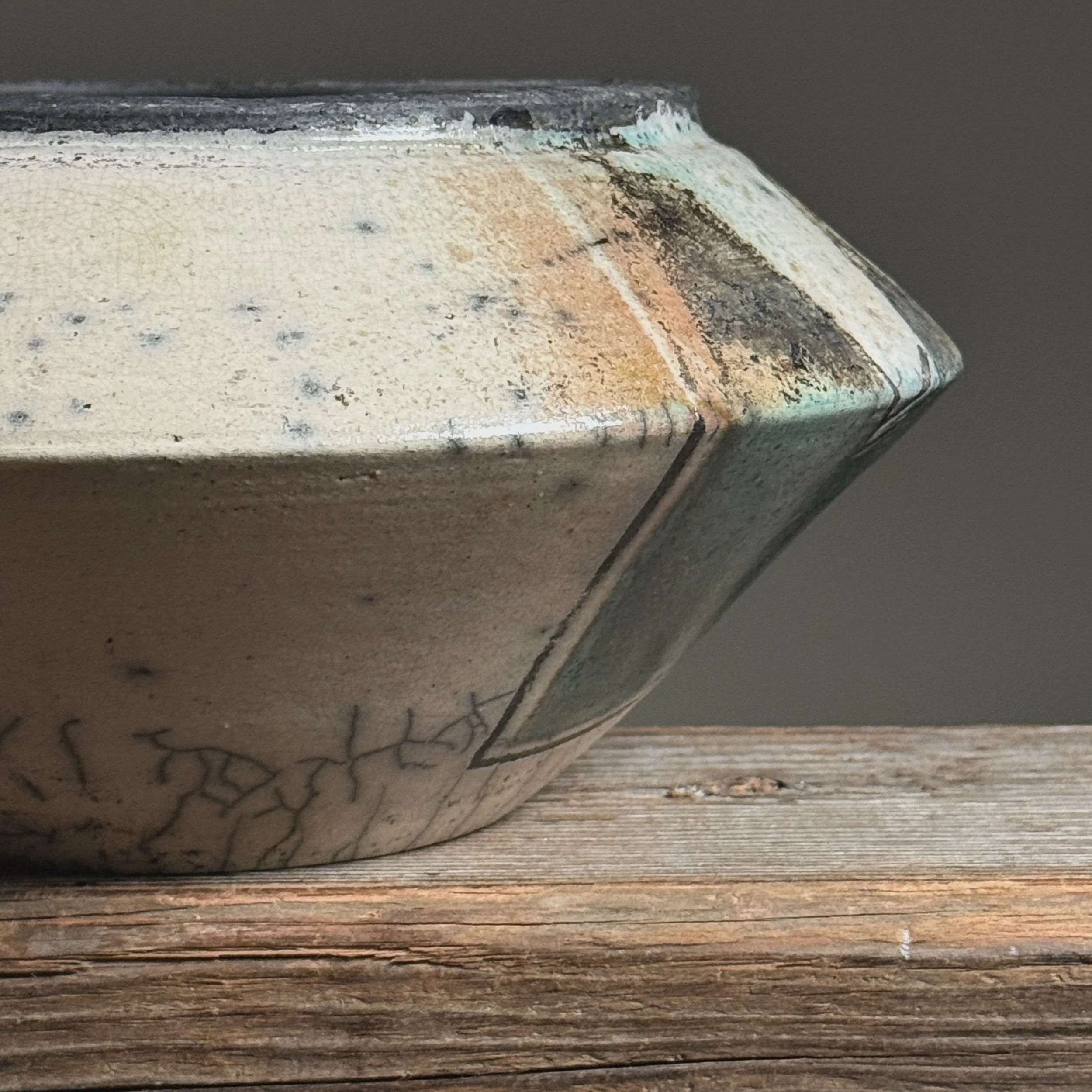 Close-up of ash marks. Raku firing effects. Ash settled on glaze surface.