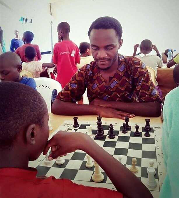 A student and instructor playing Chess at the Katwe Chess Center