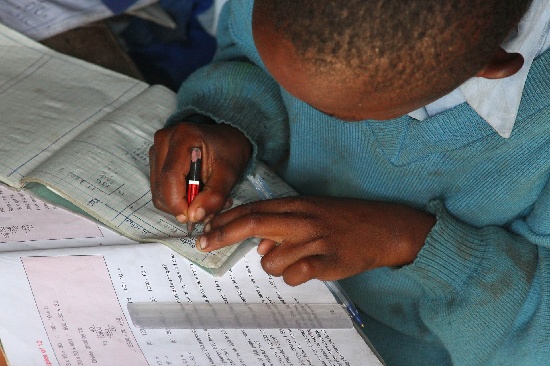 A young boy is working on a math assignment