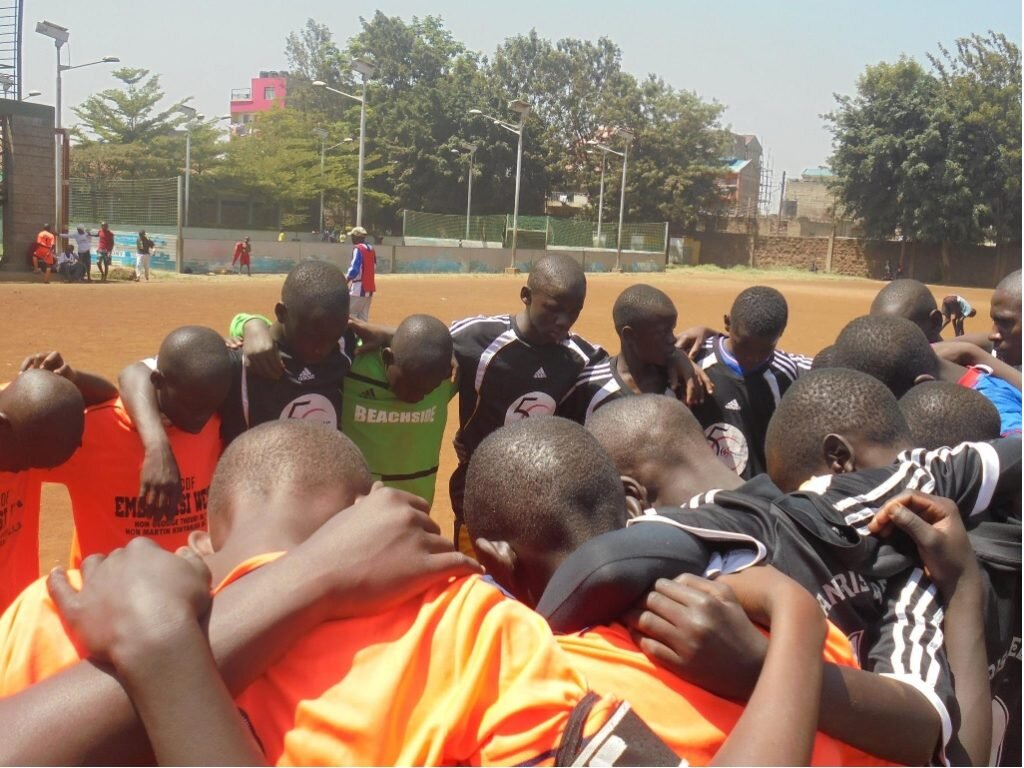 Kenyan-players-pray-before-a-match-1024x768.jpg