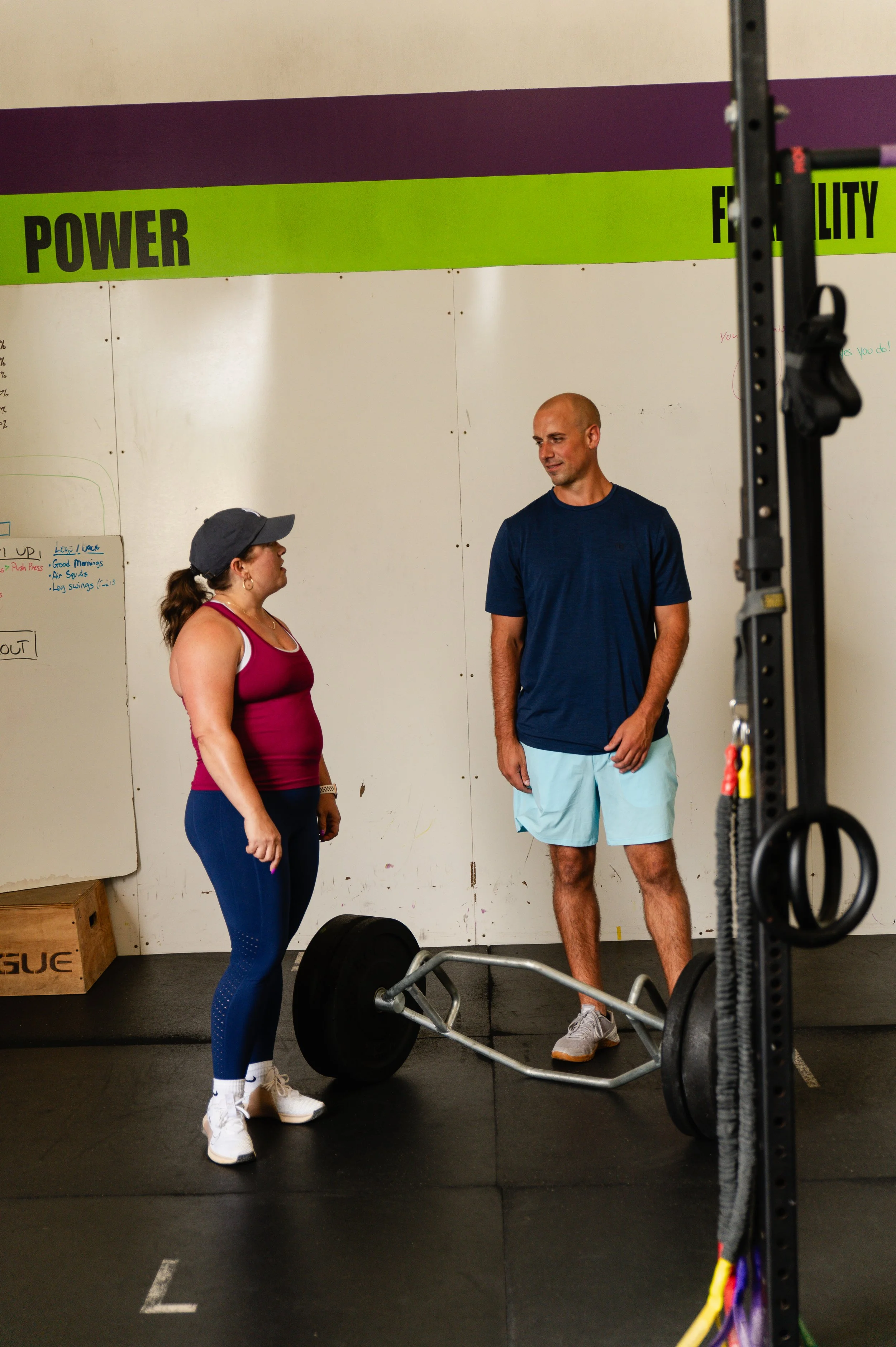 Dr. Tony Farina and adult athlete reviewing technique during adult group training session at pick health & performance
