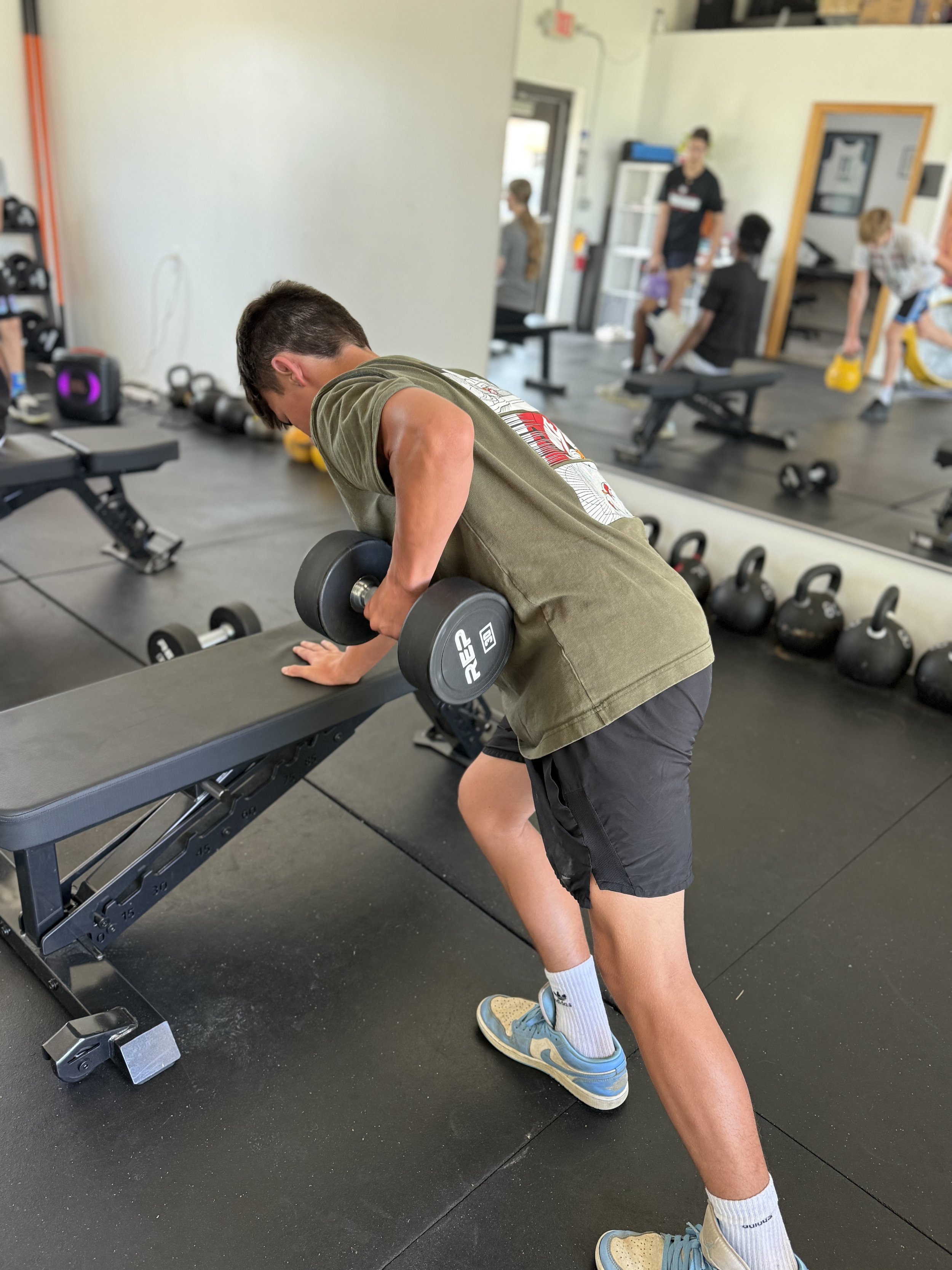 high school basketball player strength training during group sports performance training at pick health & performance