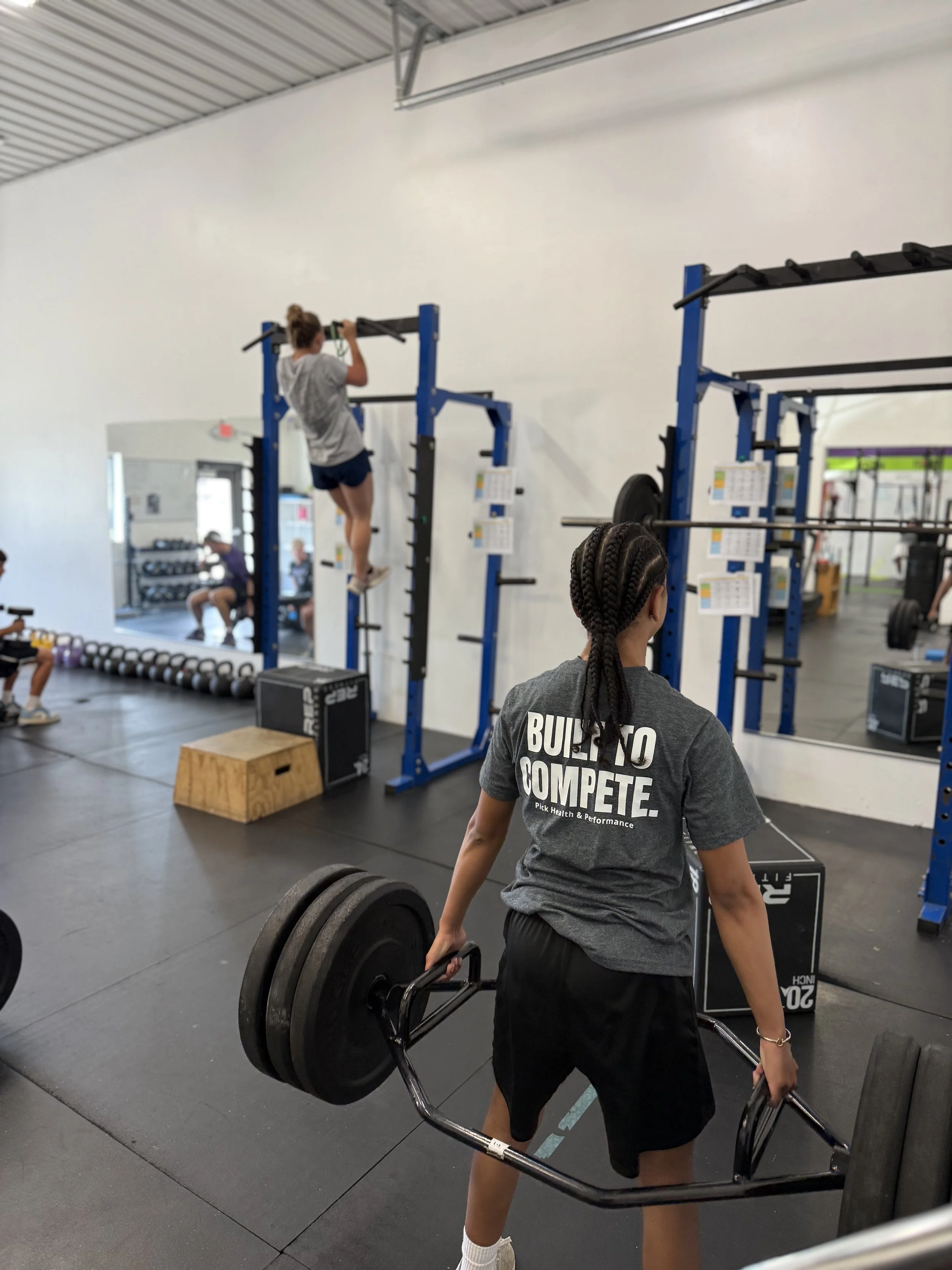 High school athlete in a Pick Health & Performance shirt during a sports performance training session