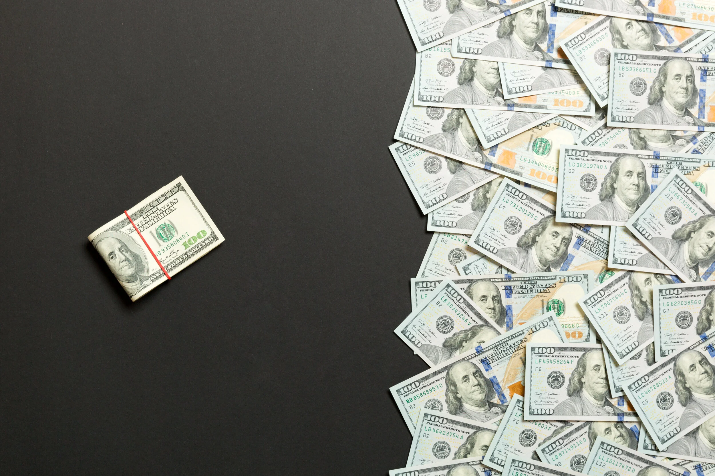 heap-hundred-dollar-bills-colored-background.jpg?format=2500w