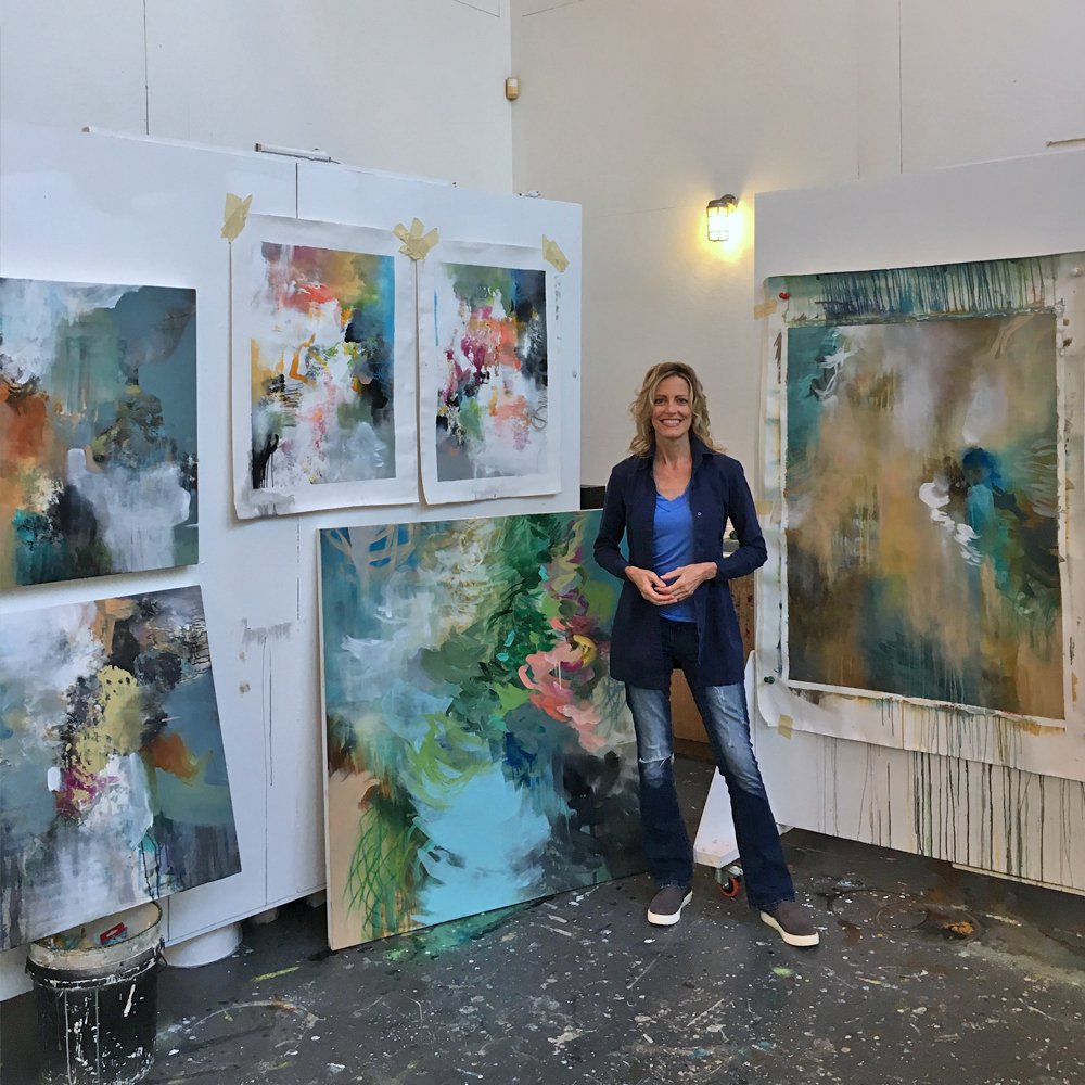 Cat Tesla  standing with new nature-inspired abstract paintings.jpg