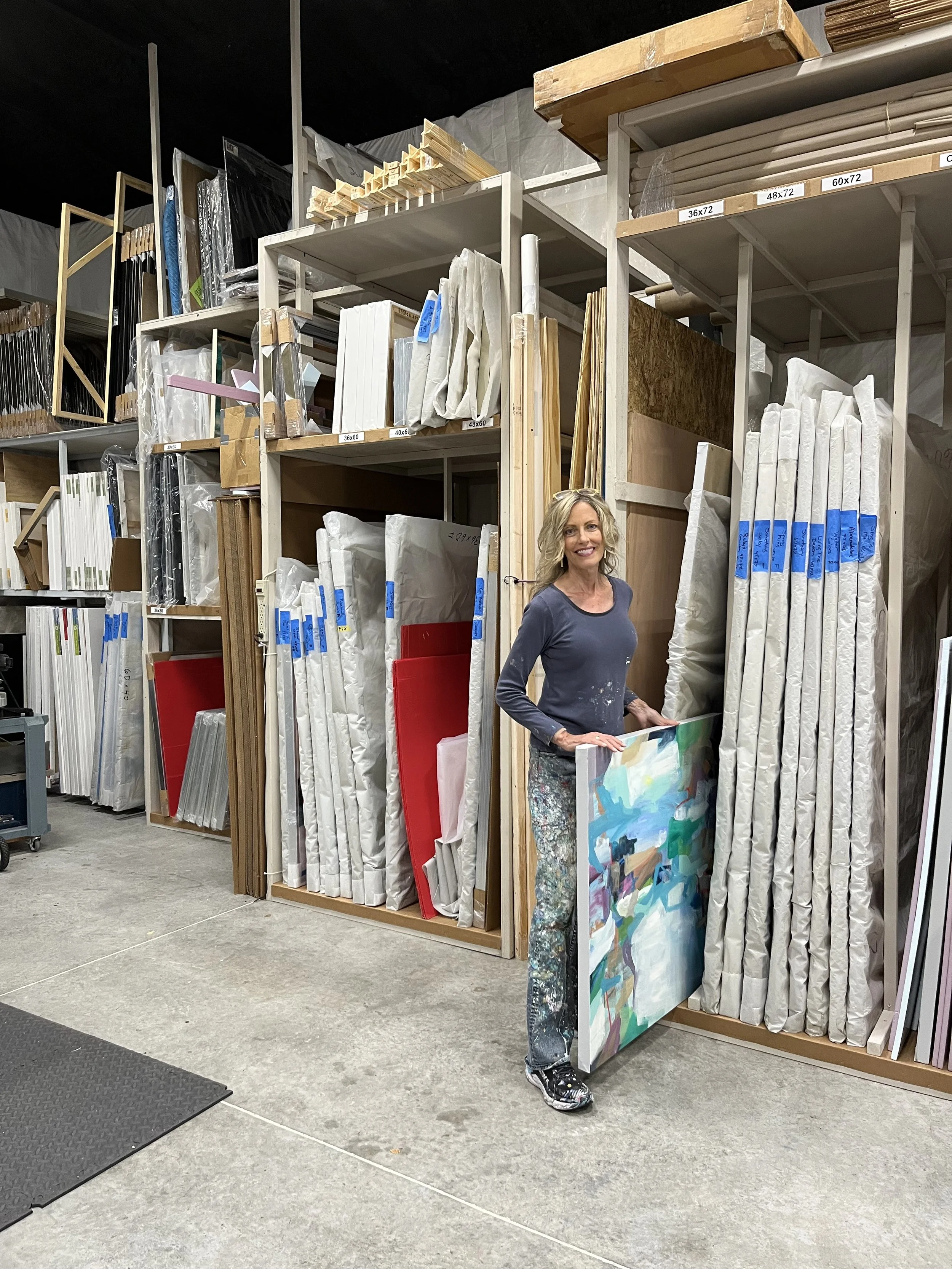 Cat Tesla in her studio with her paintings.jpg