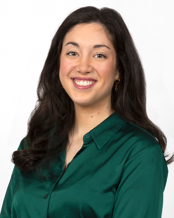Young woman in purple t-shirt holding a speech bubble with a stethoscope drawing, smiling.