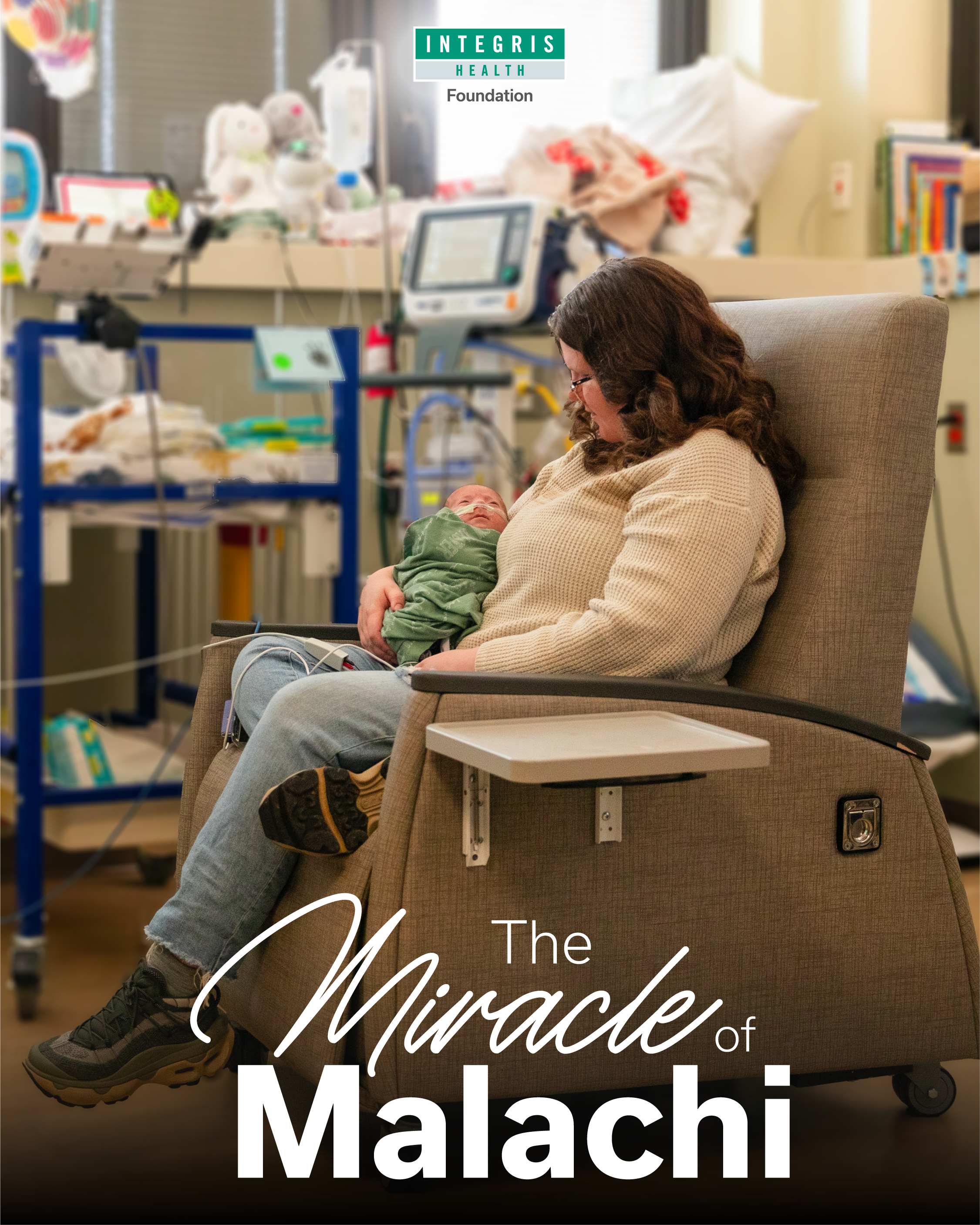 A woman holding a newborn baby in a hospital room with medical equipment and caring supplies visible in the background.