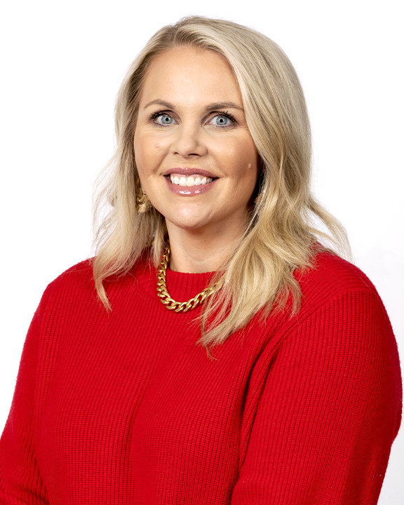Woman holding a speech bubble sign with a ribbon symbol, symbolizing breast cancer awareness.