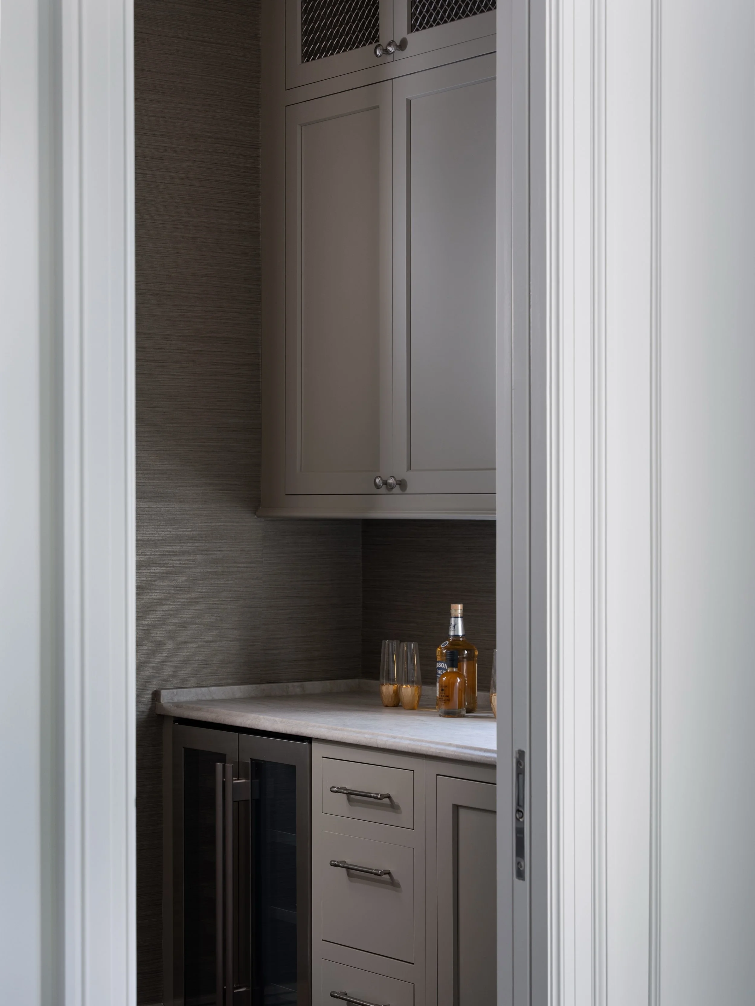 Proof that a moody vibe doesn&rsquo;t have to feel stuffy&mdash;this butler&rsquo;s pantry hits that perfect balance of dark, cozy, and cool, totally leveled up by Bullseye custom cabinets that hide the clutter in style.
