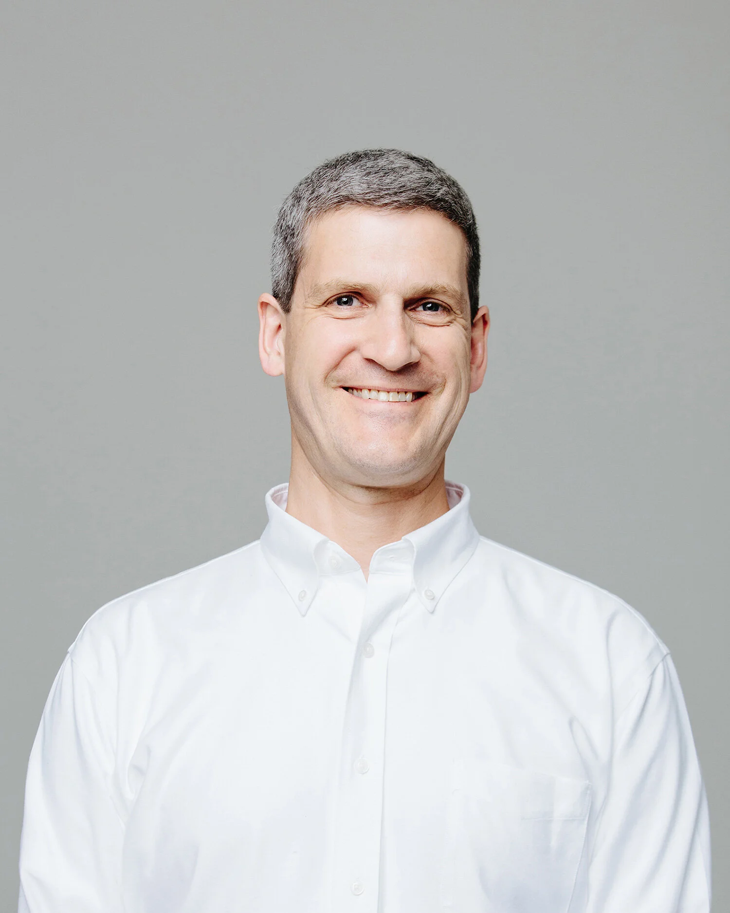 headshot of a smiling man