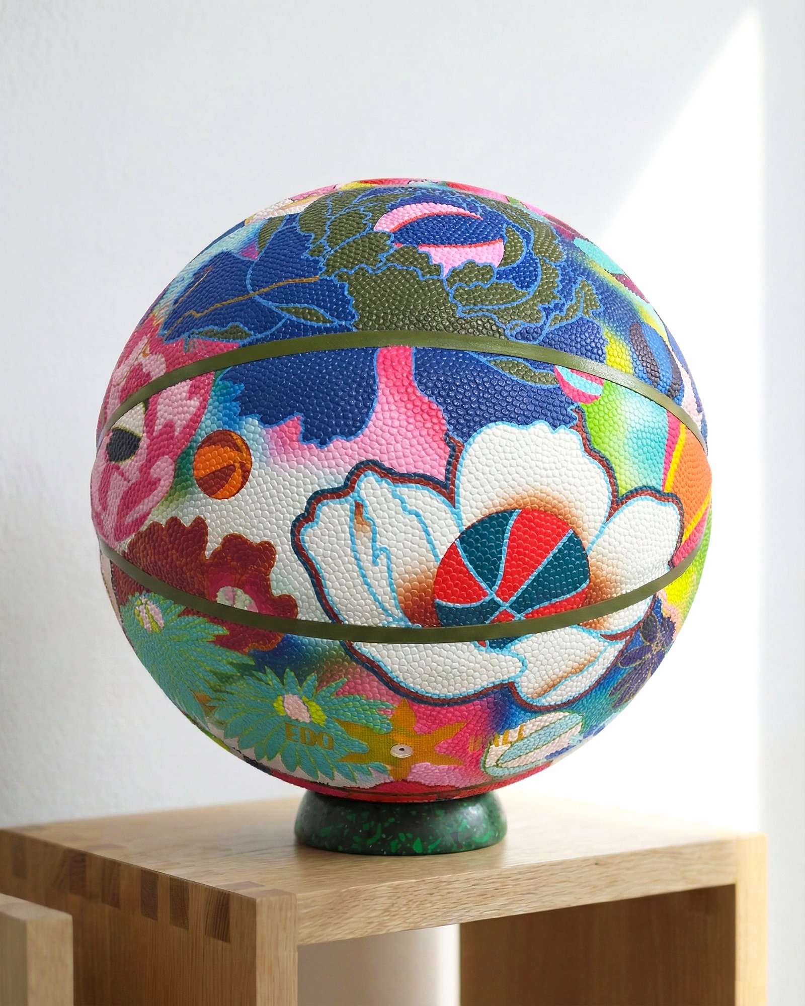 Edo Ball collectible art object, designer basketball with colorful floral embroidery-style patterns, coffee table decor.