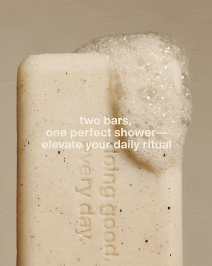 A bar of soap with foam on top and embedded message reading 'two bars, one perfect shower— elevate your daily ritual'