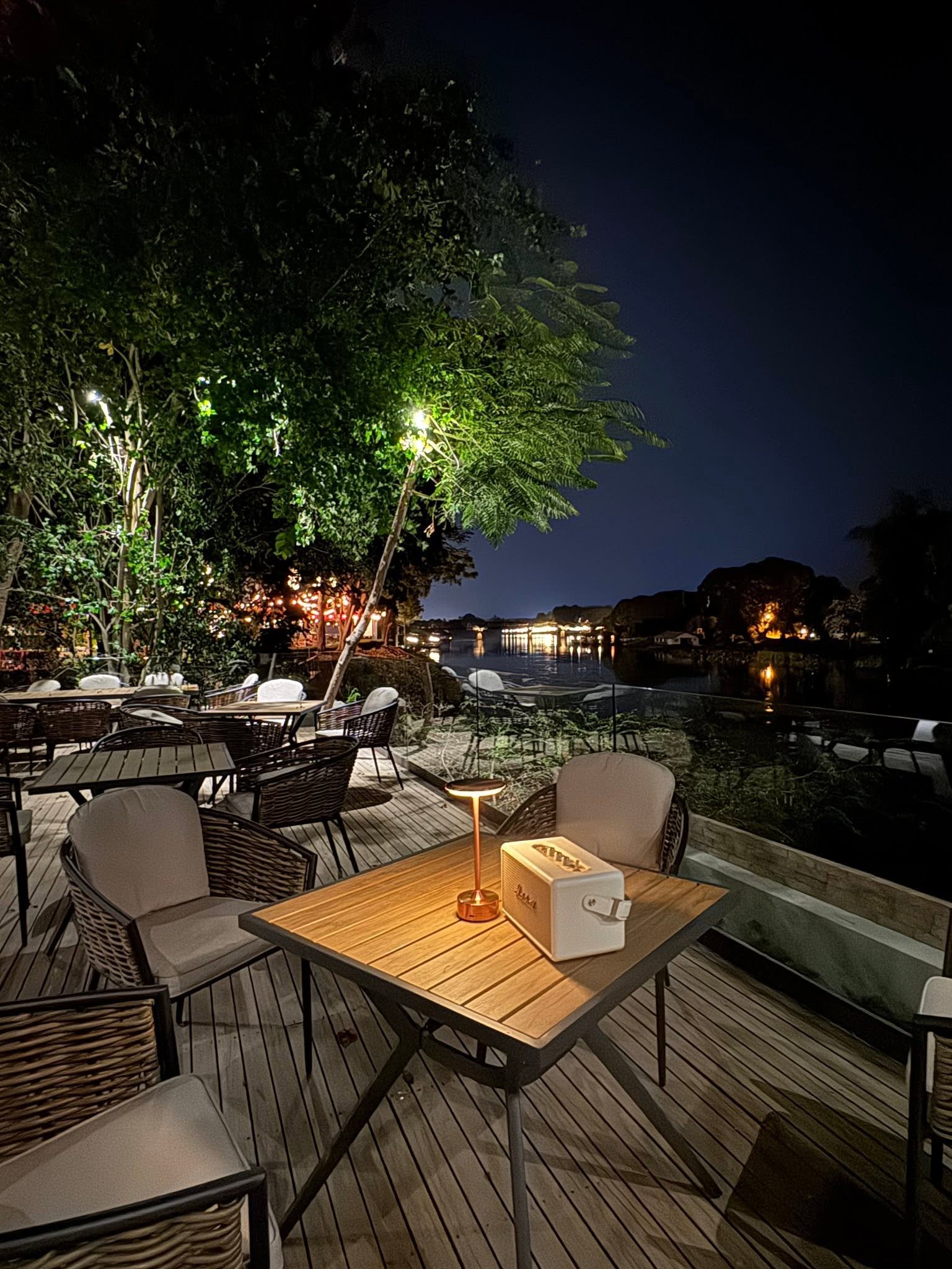 Makhamvilla balcony by riverside of River Kwai, Kanchanaburi, overlooking River Kwai bridge.