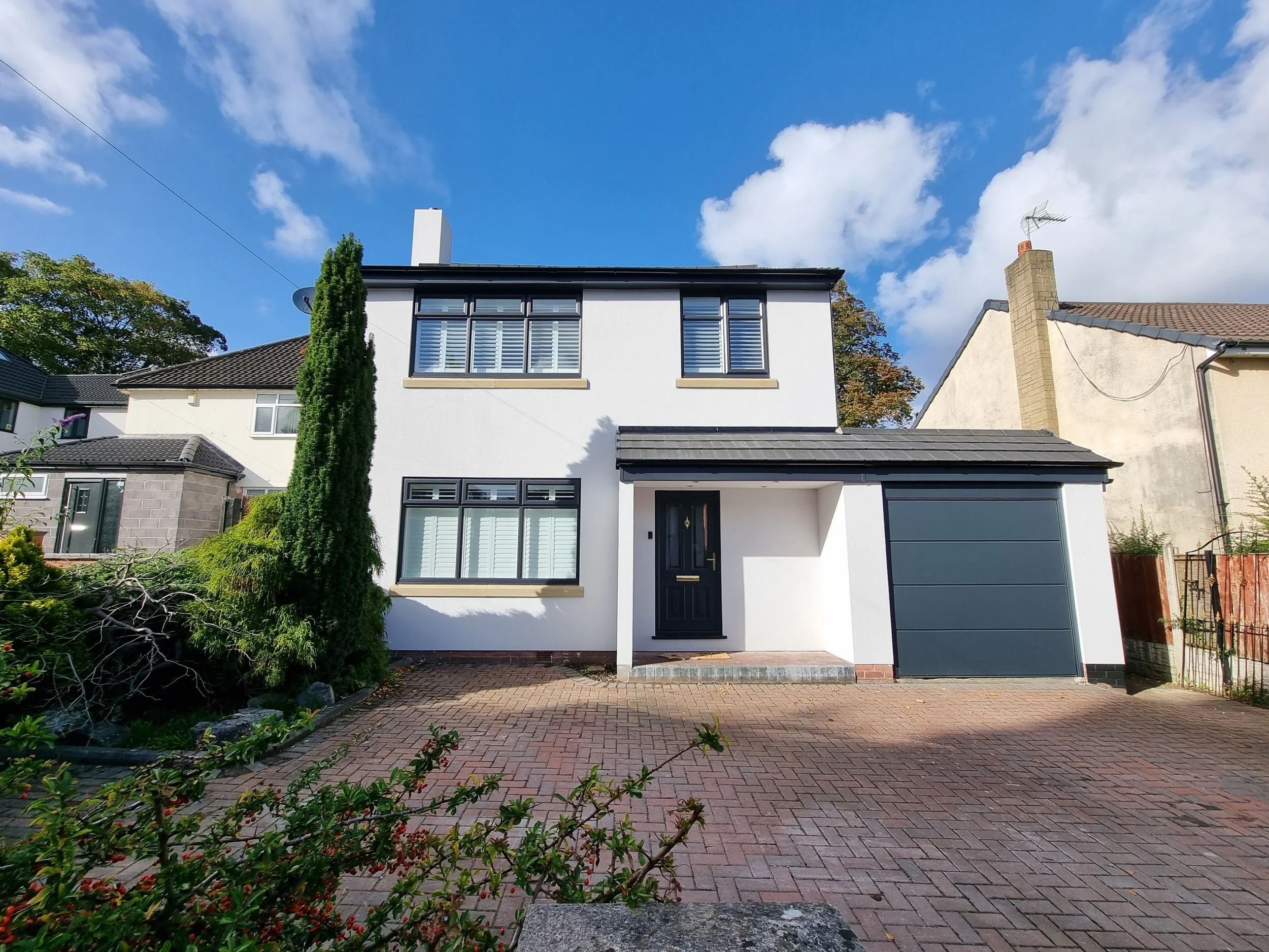 Modern two-story white house with Silicone render, K Rend, Rendering Liverpool, Wirral, renderers near me, house rendering, ATLAS render, thin coat render, render THIS