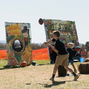 Two Boys Playing Lawn Games at Pumpkin Festival