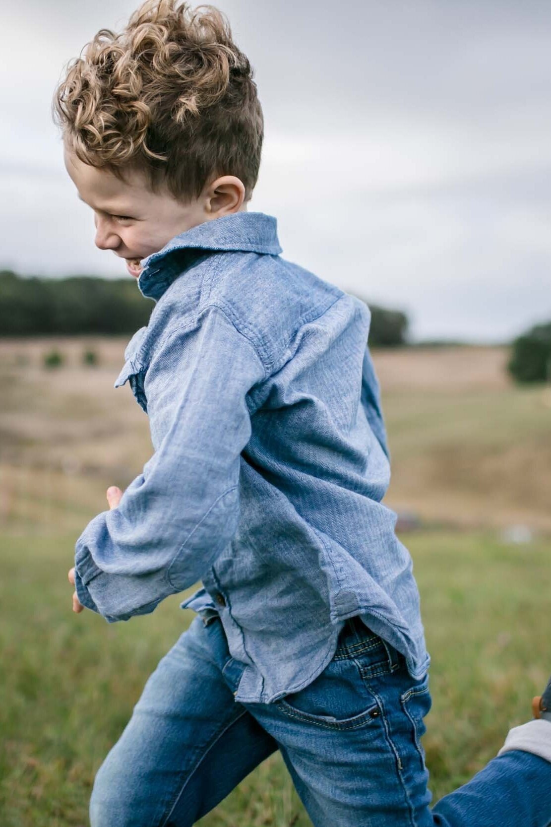 Happy Young Boy Running Through Sinkland Farms Fields