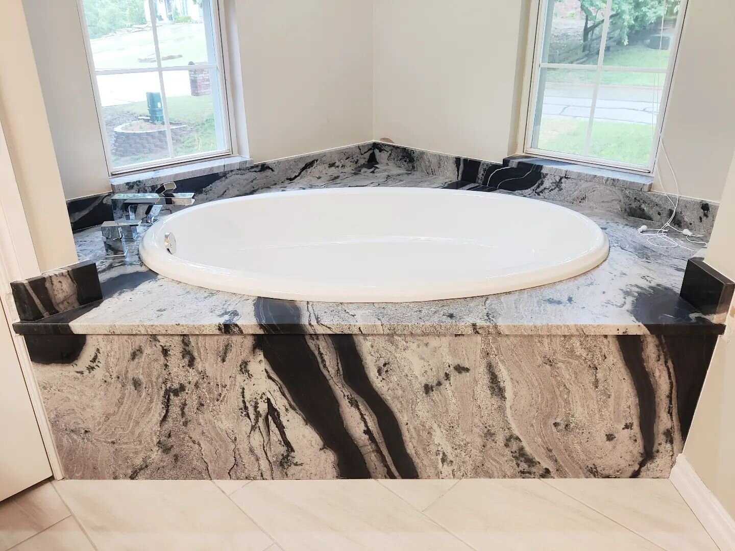 This tub deck was made with Eclipse leathered granite from @pacificshorestonestulsa the three pieces for the front panel lined up despite coming out of different parts of the slab and waterfall almost perfectly. If it's a big enough slab, we can prob