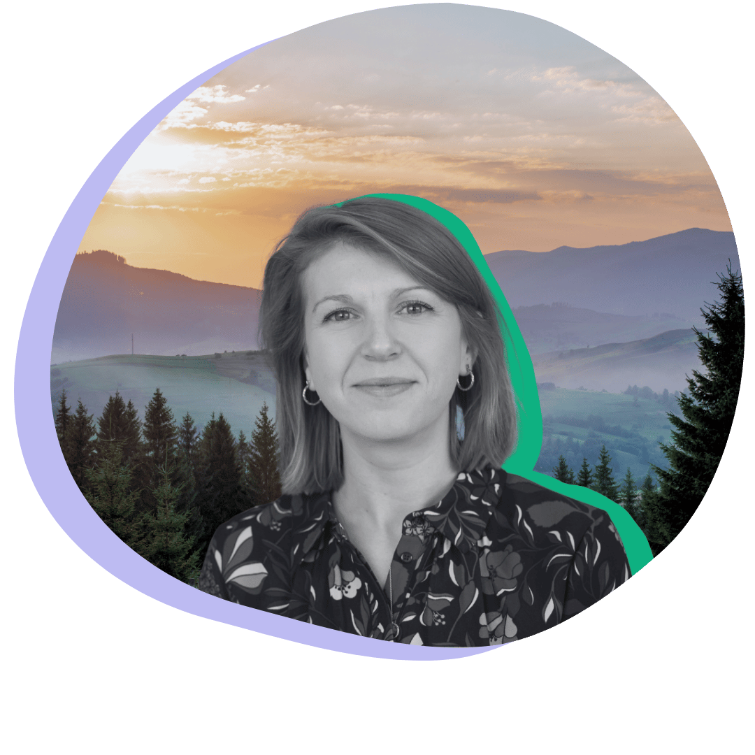 Black and white photo of a white woman smiling with her mouth closed.