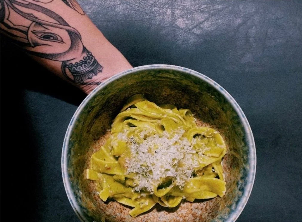 Handmade tagliatelle with fresh basil pesto served in a handcrafted ceramic bowl, prepared by a private chef for intimate dining in the Roaring Fork Valley.
