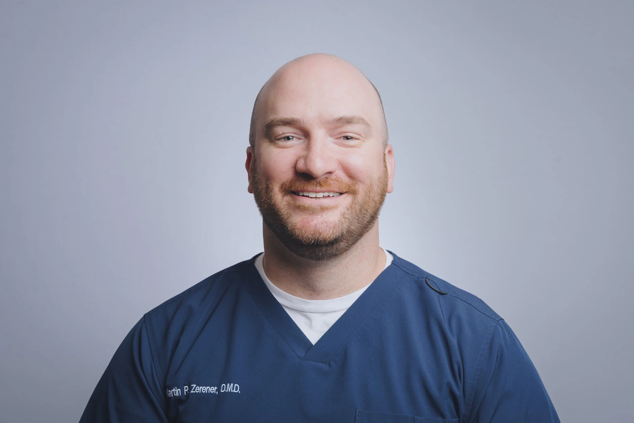 A smiling male dental professional