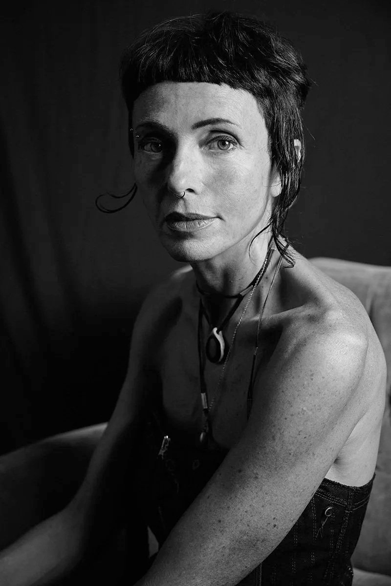 Woman looking at camera, holding a lot of emotion