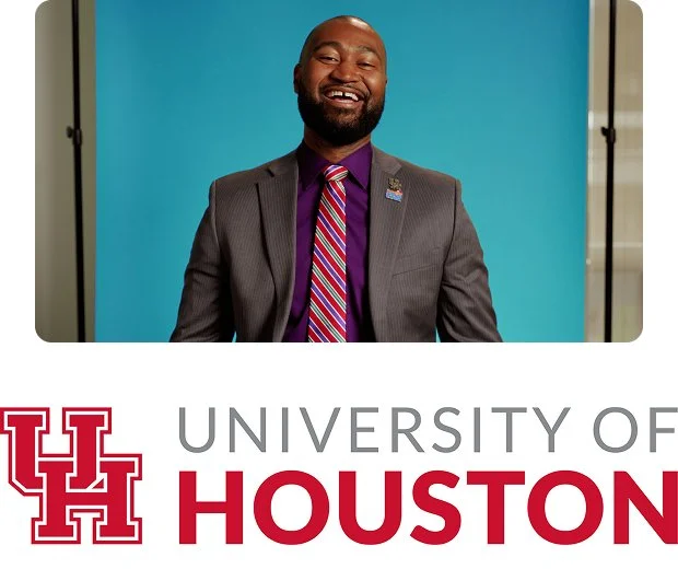 A black man with short dark hair and a short mustache and beard wears a white suit, blue collared shirt, and black bowtie with white polka dots in front of a yellow background above the University of Houston name and logo.