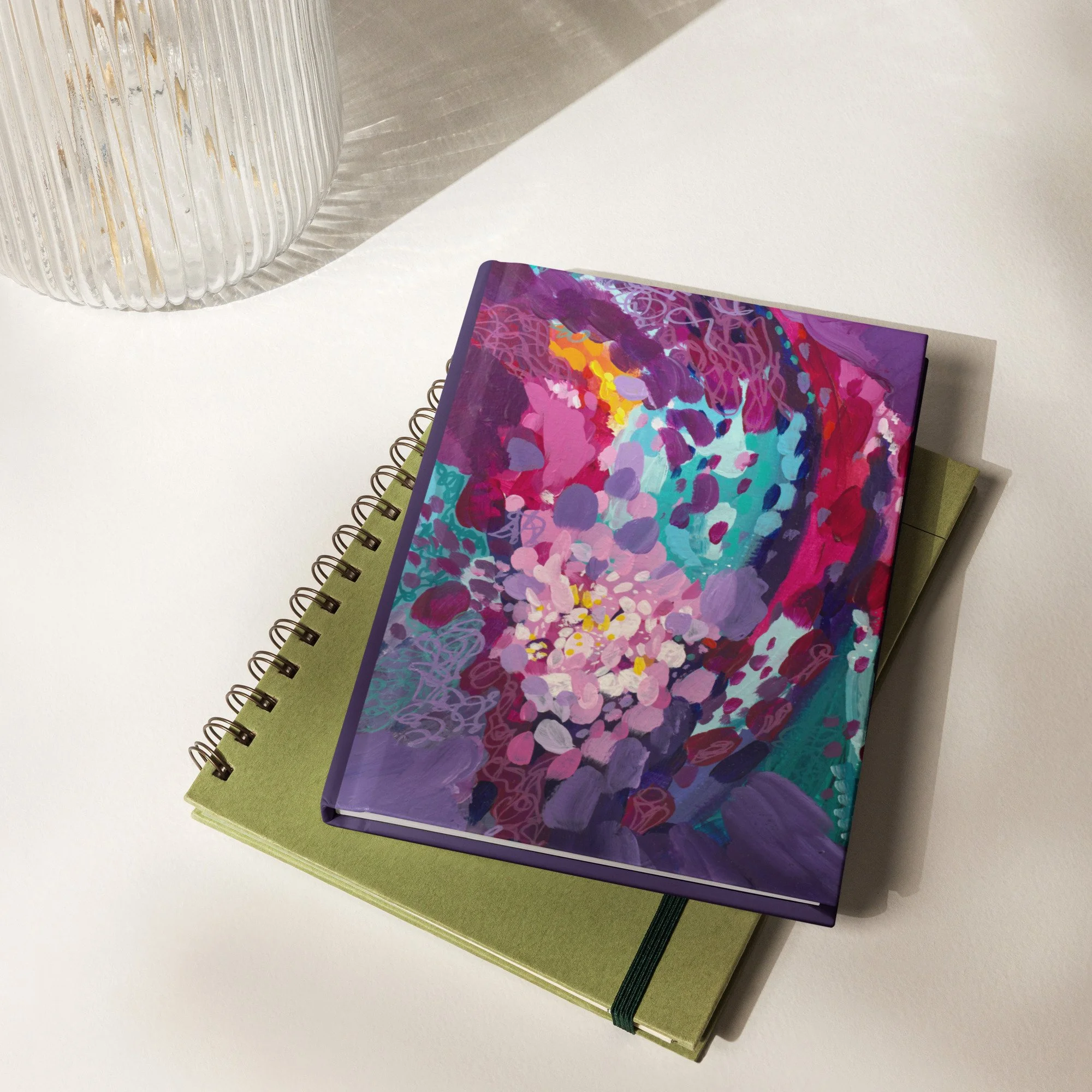 Flat lay of two journals on a desk.