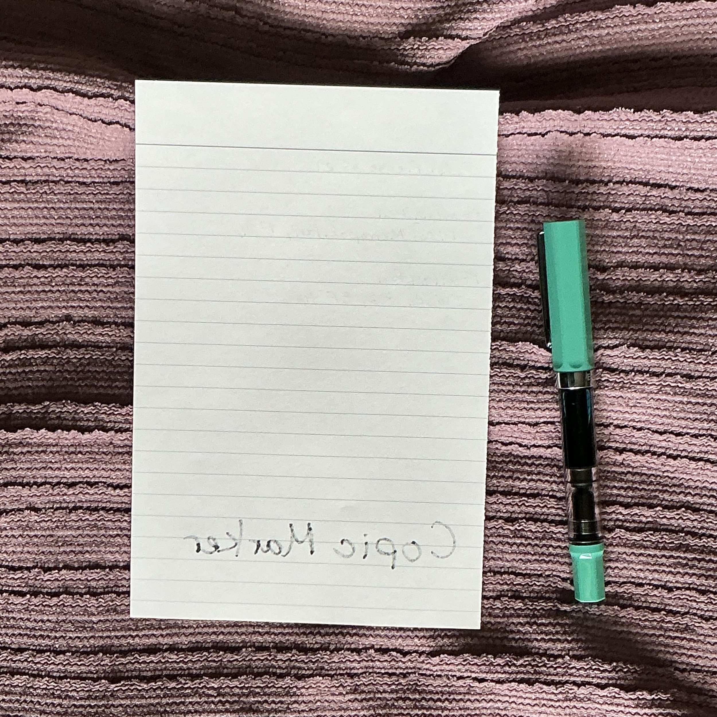 Pen test of the paper. Fountain pens do not ghost or bleed through. The Copic marker does not bleed through with normal writing but it does ghost through the paper.