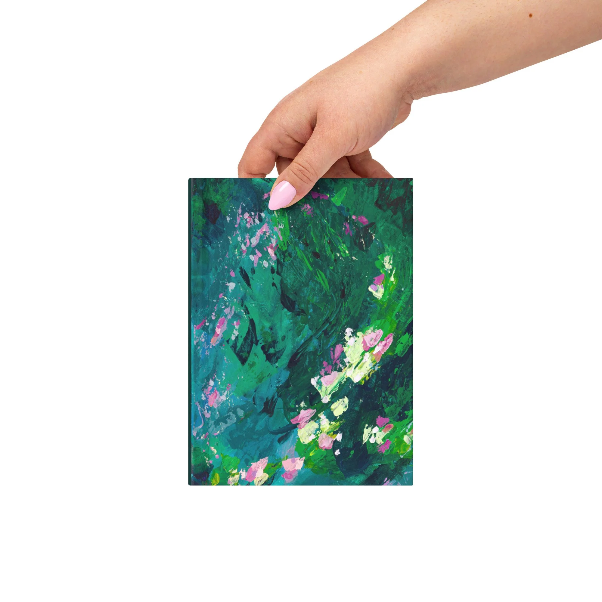 Human hand holding the hardcover journal