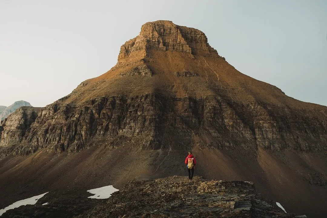 This was Glacier National Park in its truest form&mdash;harsh, towering, and humbling. The late afternoon light hit the mountain just right, tracing every crack and fold in its face. A few stubborn snow patches lingered, reminders of the unforgiving 