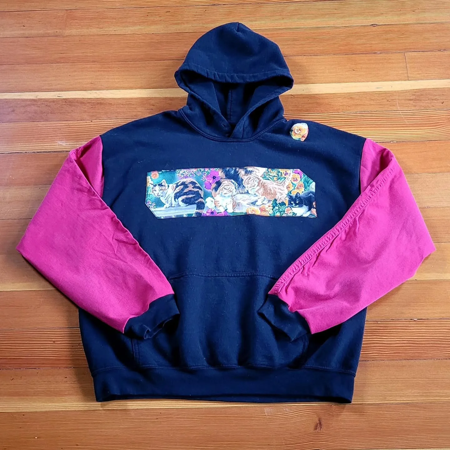 My goal is to reduce fashion waste. One way I do this is by reworking old, unloved sweaters into fun wearable art. The original sweater's logo was completely worn out and dated. There were also multiple paint stains on the shoulder, sleeves, and back