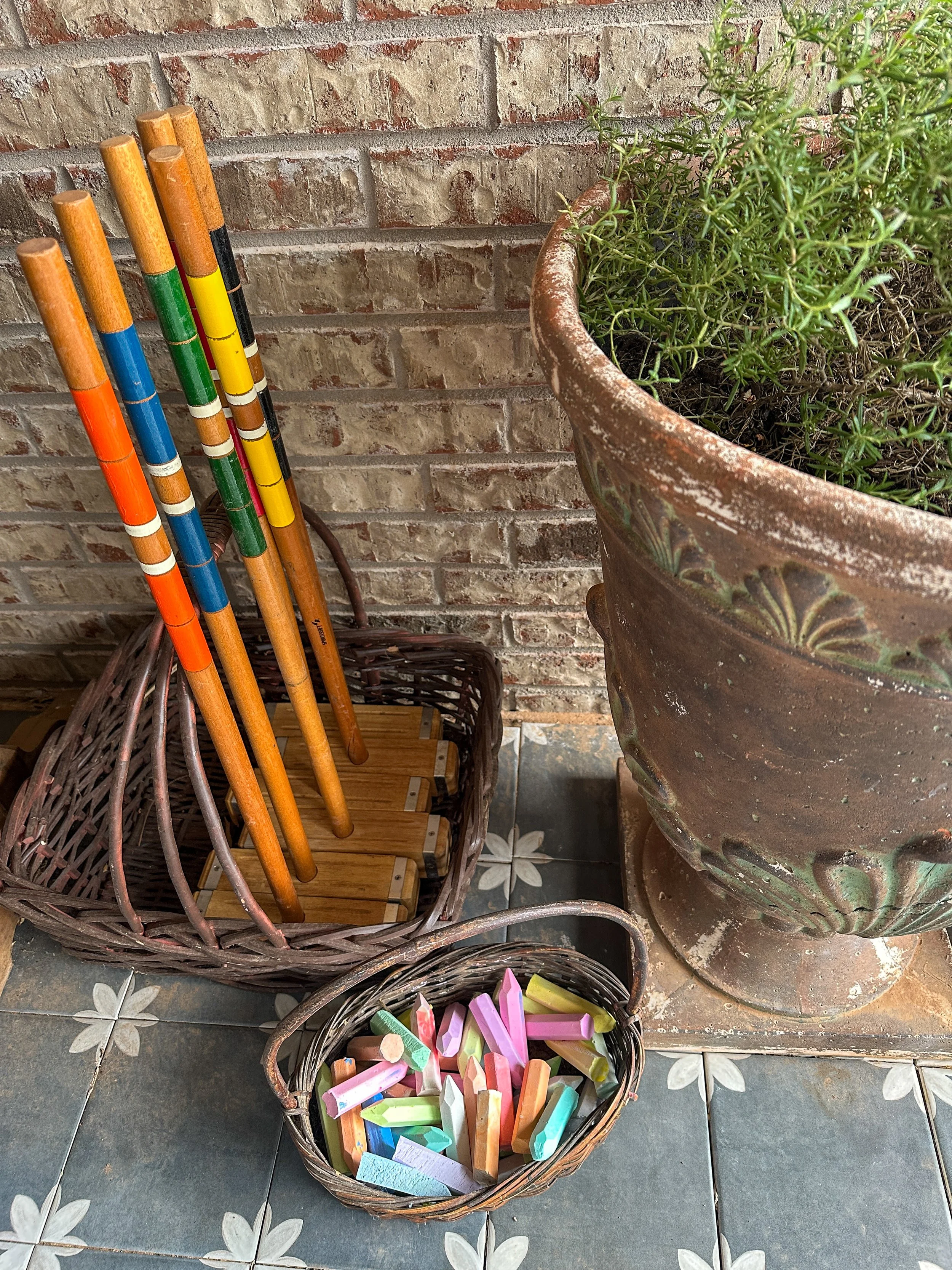 Basket of colorful sidewalk chalk for summer kids activities like racetracks and hopscotch