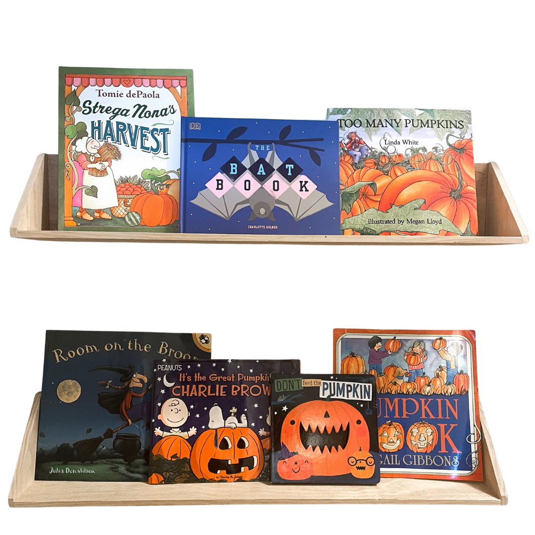 October fall-themed book shelf display for children with pumpkin and autumn books