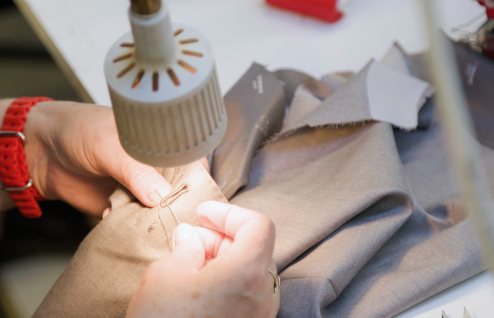 Sewing buttons onto a tweed jacket cuff