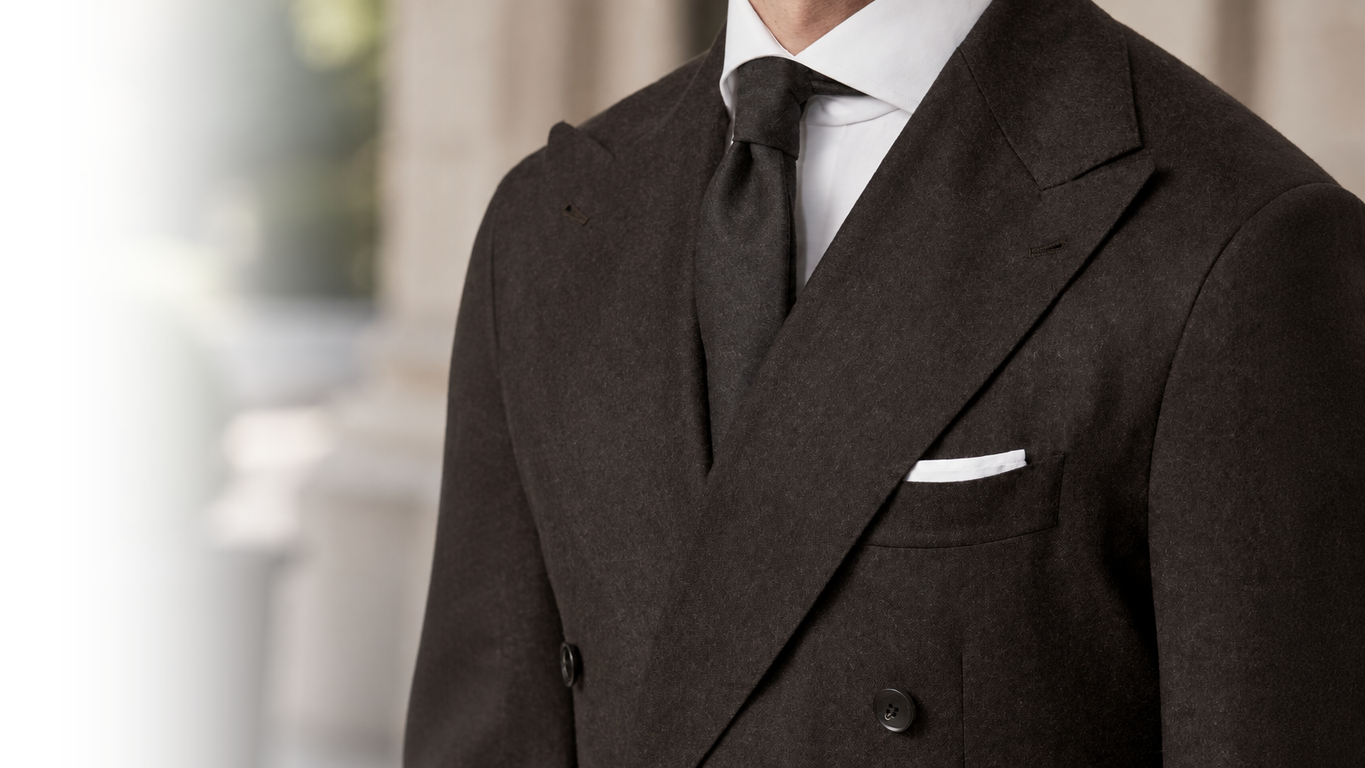 Charcoal flannel double-breasted jacket with peak lapels, white shirt and dark tie