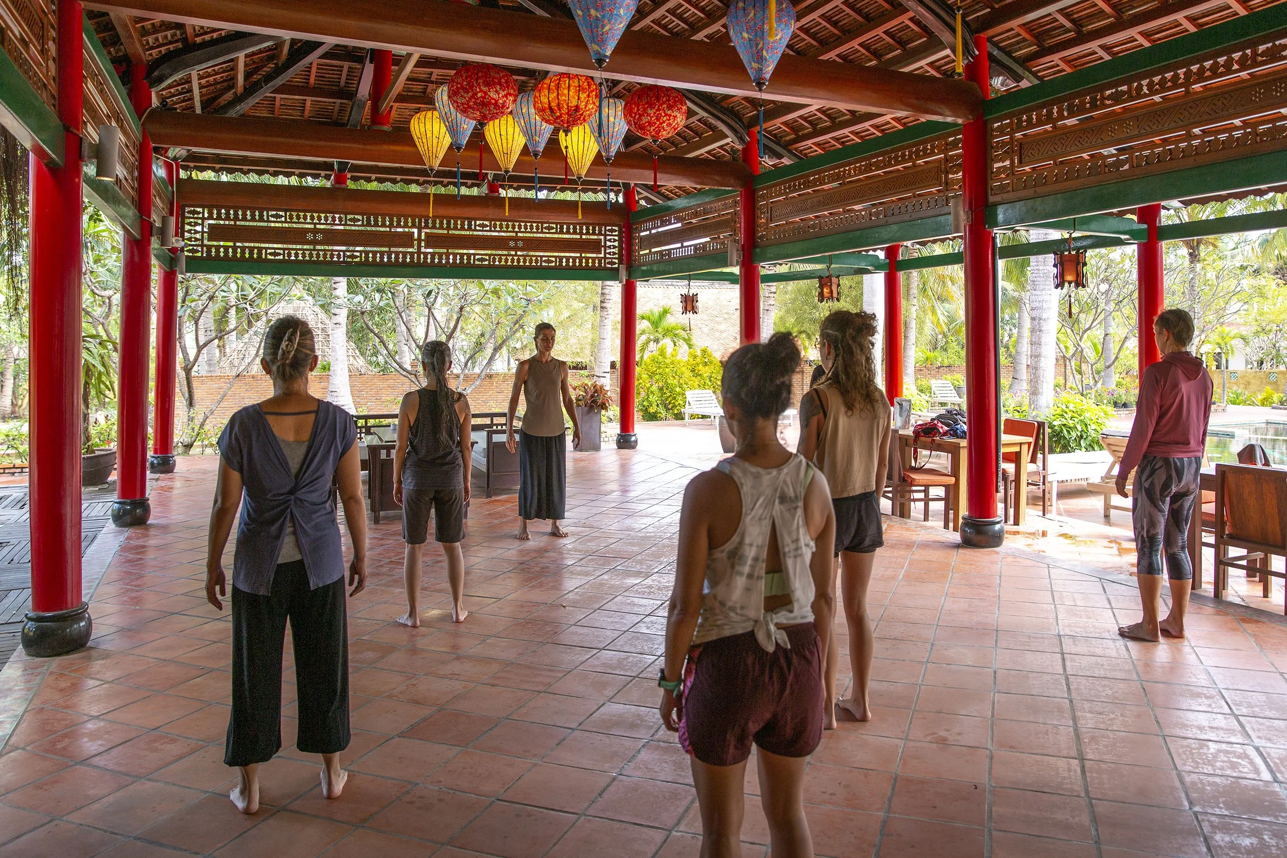 Ani Petrova leading a Taoist Qi Gong morning practice during a wellness retreat in Vietnam.