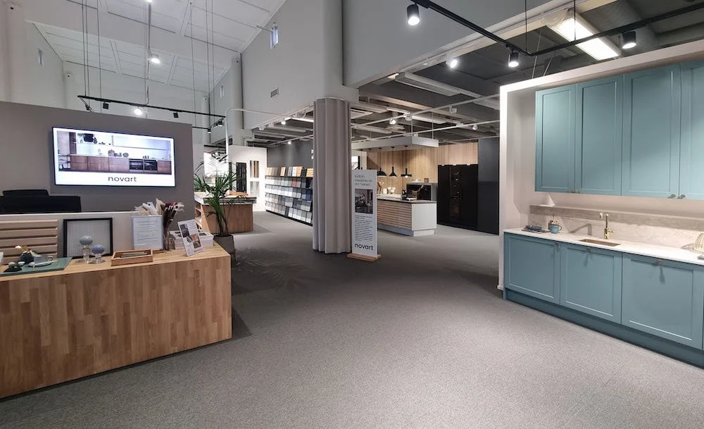 Showroom tila, jossa on keittiöalue ja sisustusnäytteitä, pintoja ja keittiötarvikkeita.