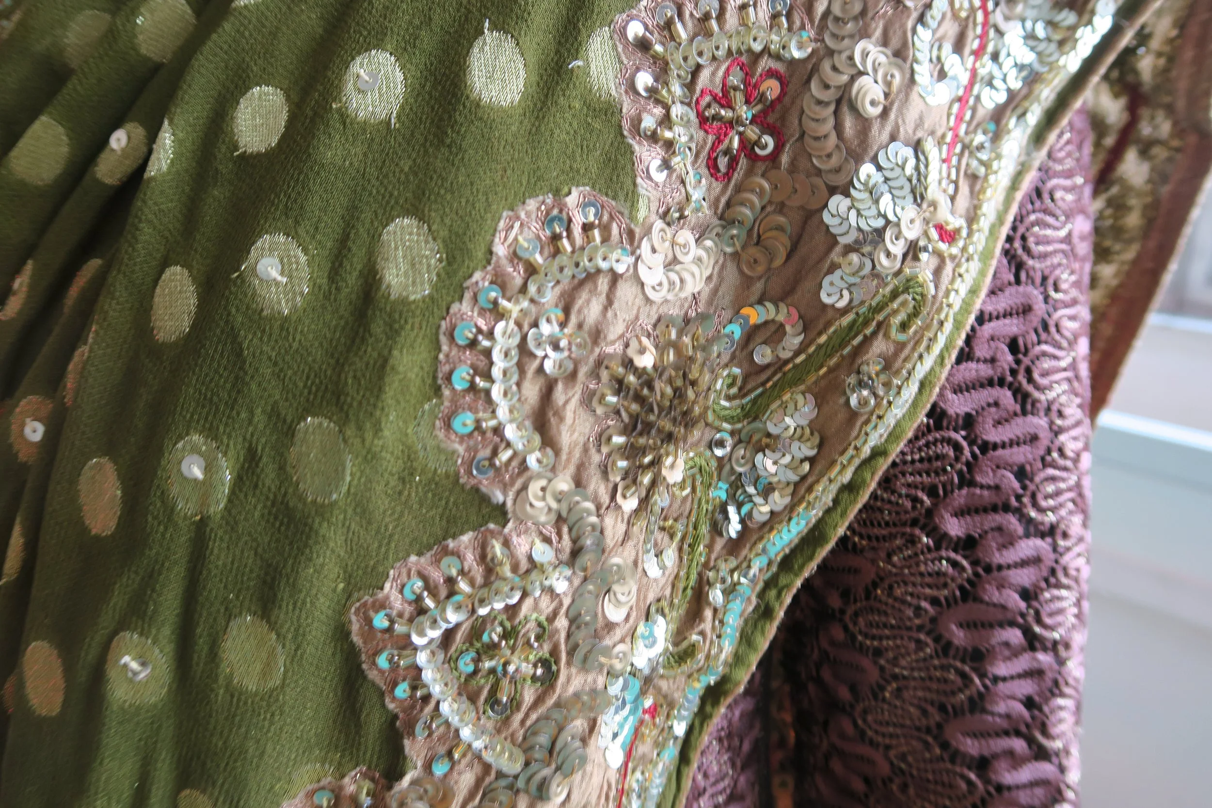 A close up of a green embroidered saree